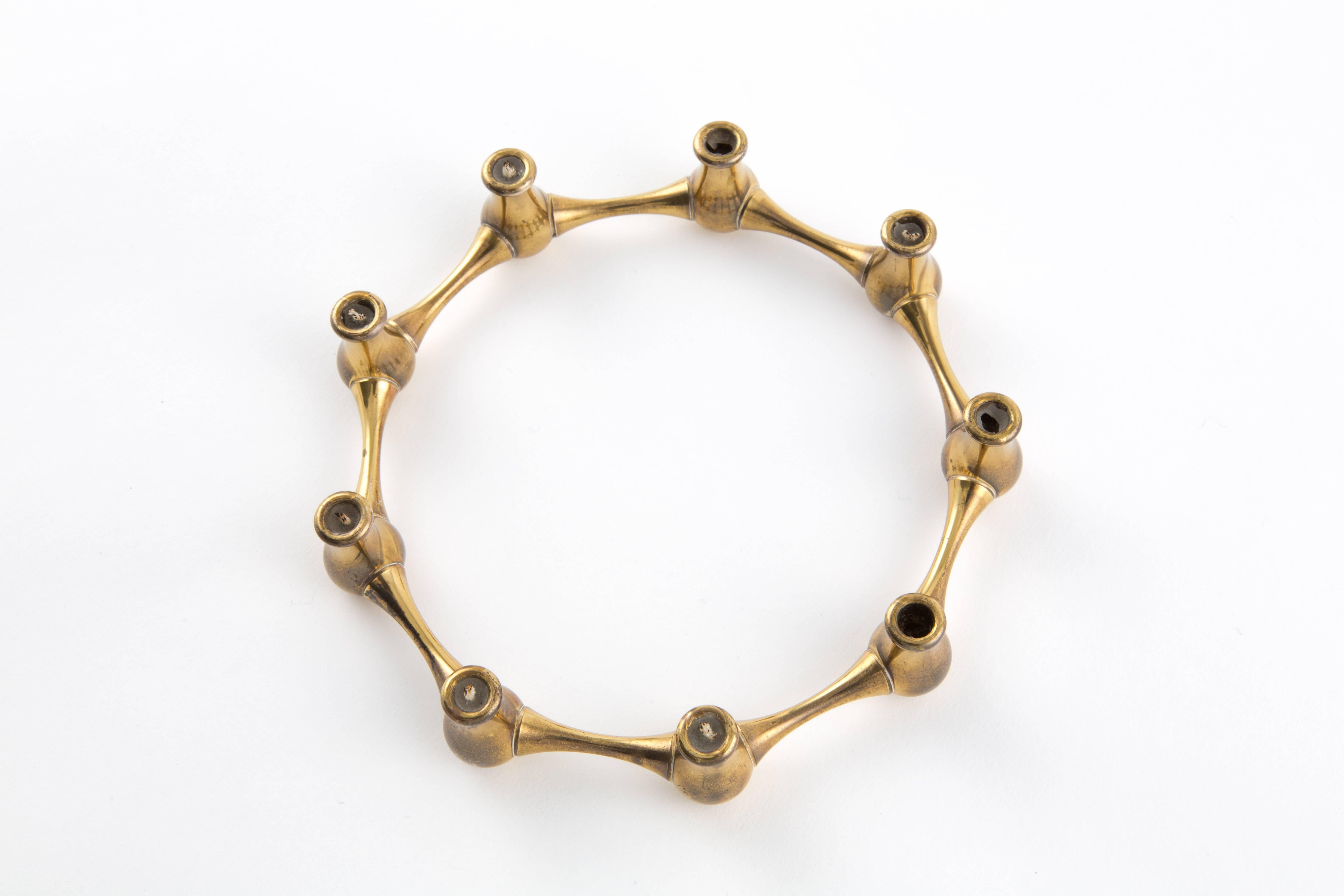 A brass candleholder from Denmark in the form of a circle. With nine candleholders.