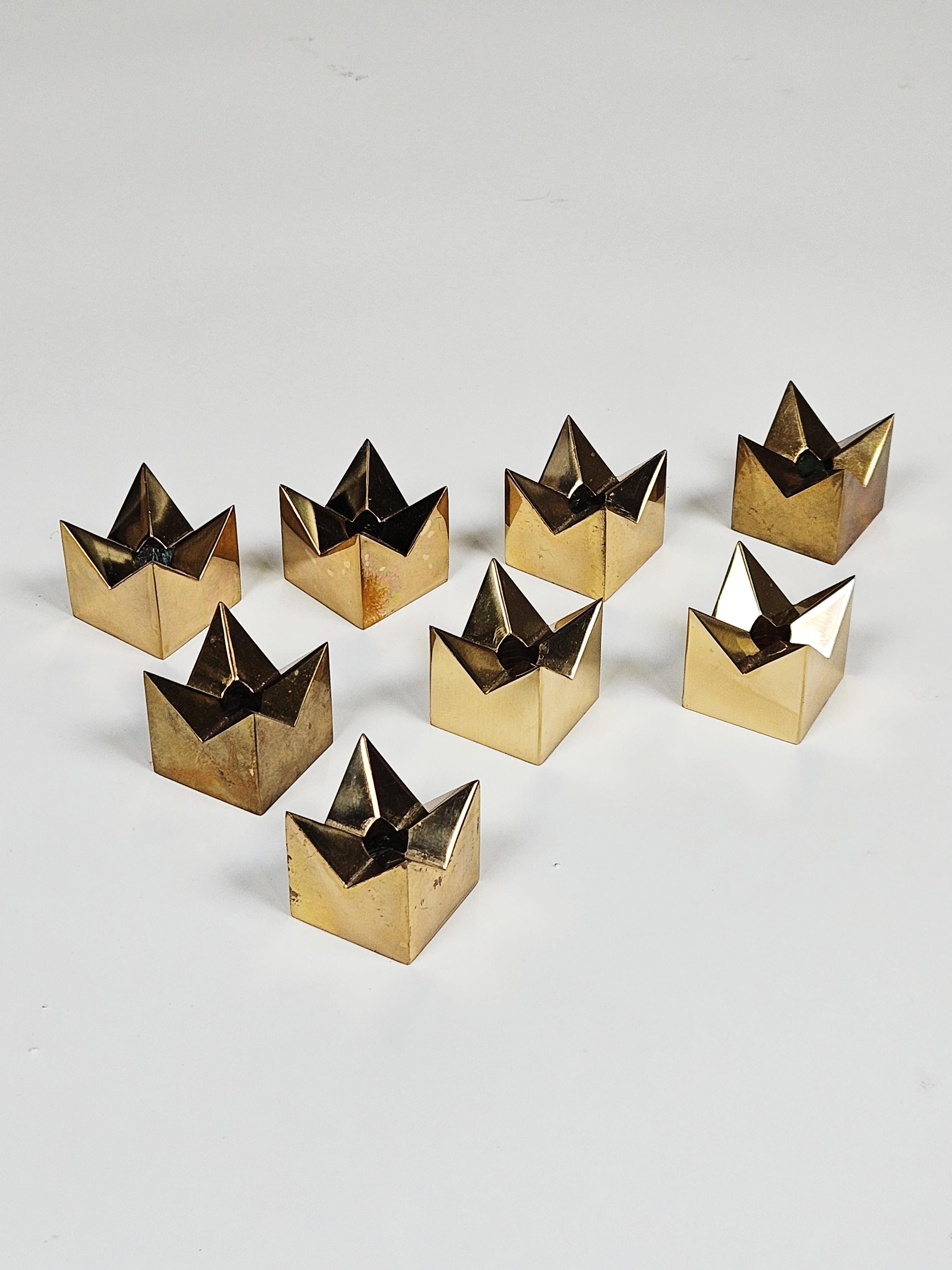 Set of eight Scandinavian modern brass candle holders designed by Pierre Forssell and produced by Skultuna in the 1960s. 

Makers mark and signature on bottom. 

Original condition with patina. 