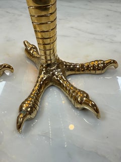 Brass candle holders designed in the shape of bird talons