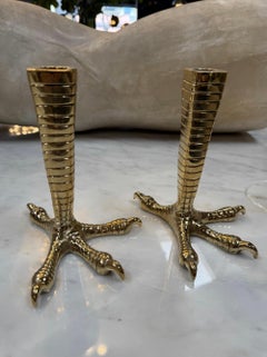 Brass candle holders designed in the shape of bird talons