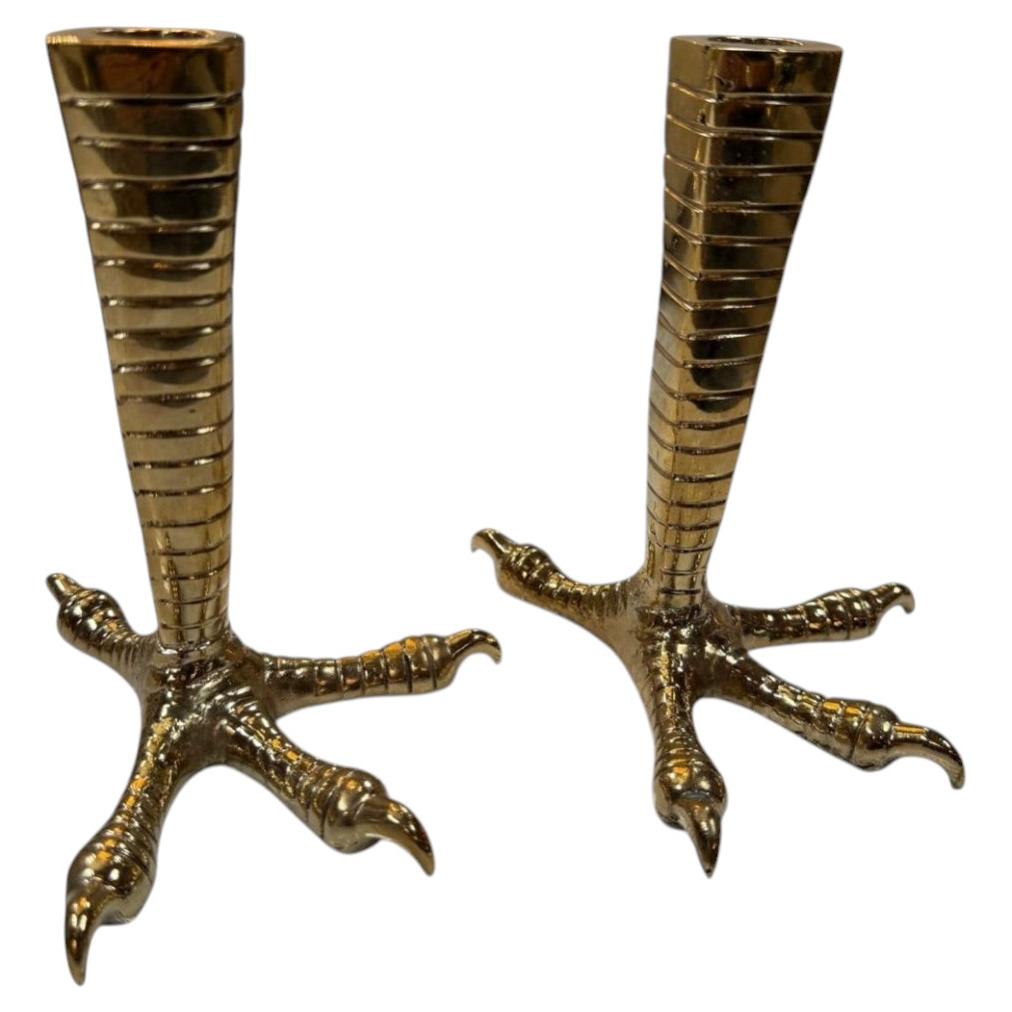 Brass candle holders designed in the shape of bird talons