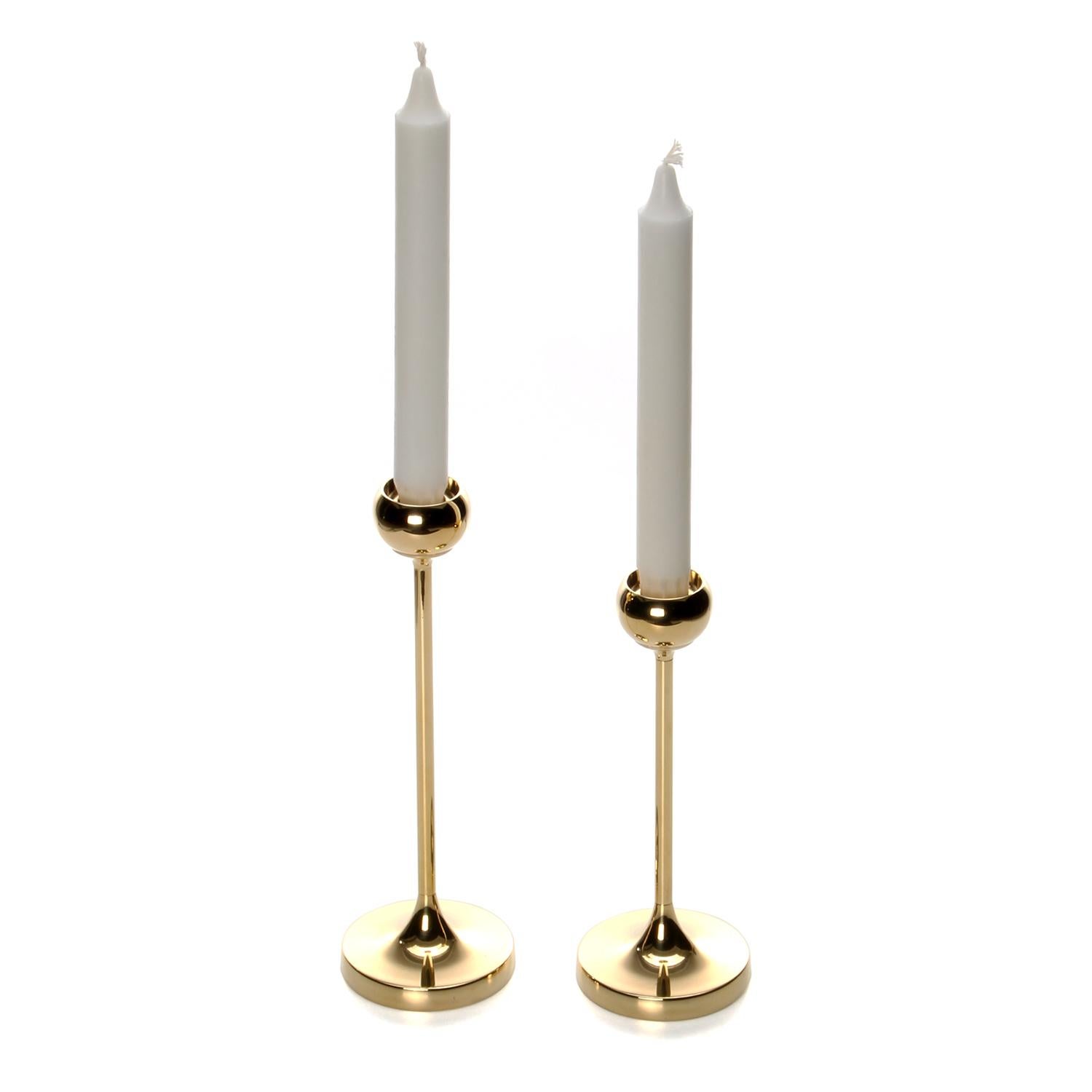 Brass candleholders- set of two 1970s Danish polished brass candlestick holders, all in very good vintage condition.

An elegant set of brass candlestick holders, each comprised of a round base from where a thin brass stick emerges, ending in a