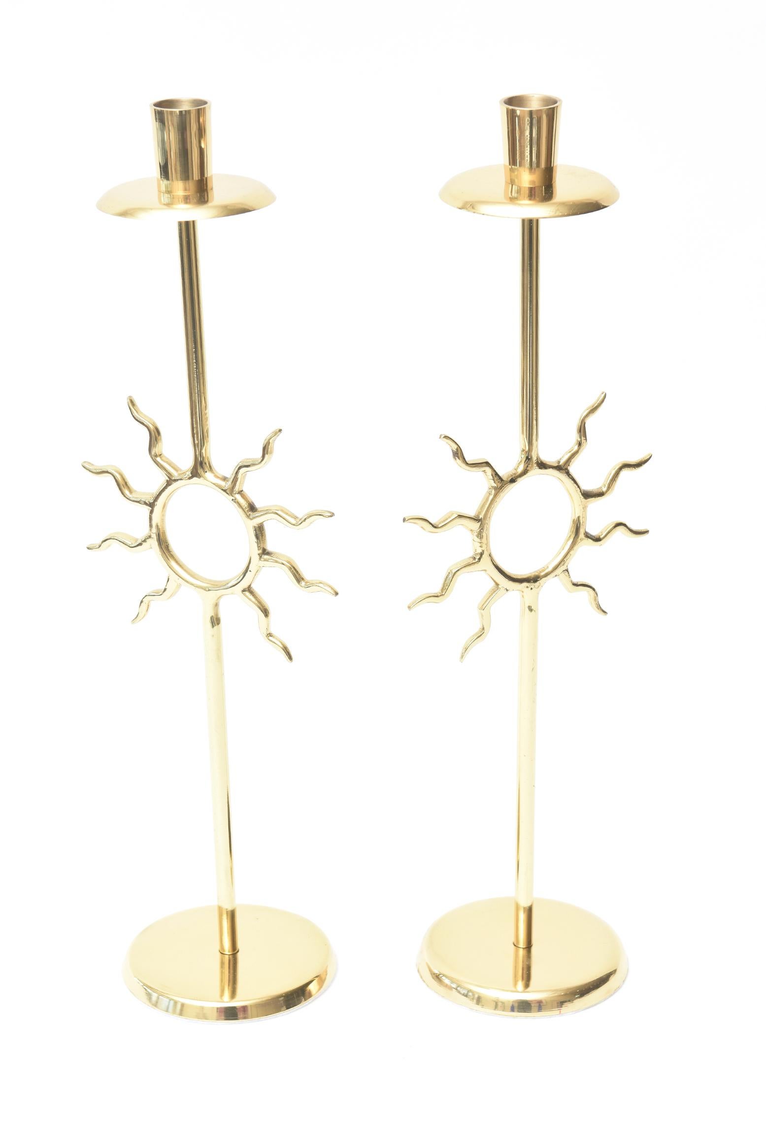 These wonderful pair of vintage brass candlesticks are very Fornasetti style with a bit of Tony Duquette whimsy. The sun motif brings happiness. They are from the 1970s. They have been professionally polished with new white felt on the bottom. They