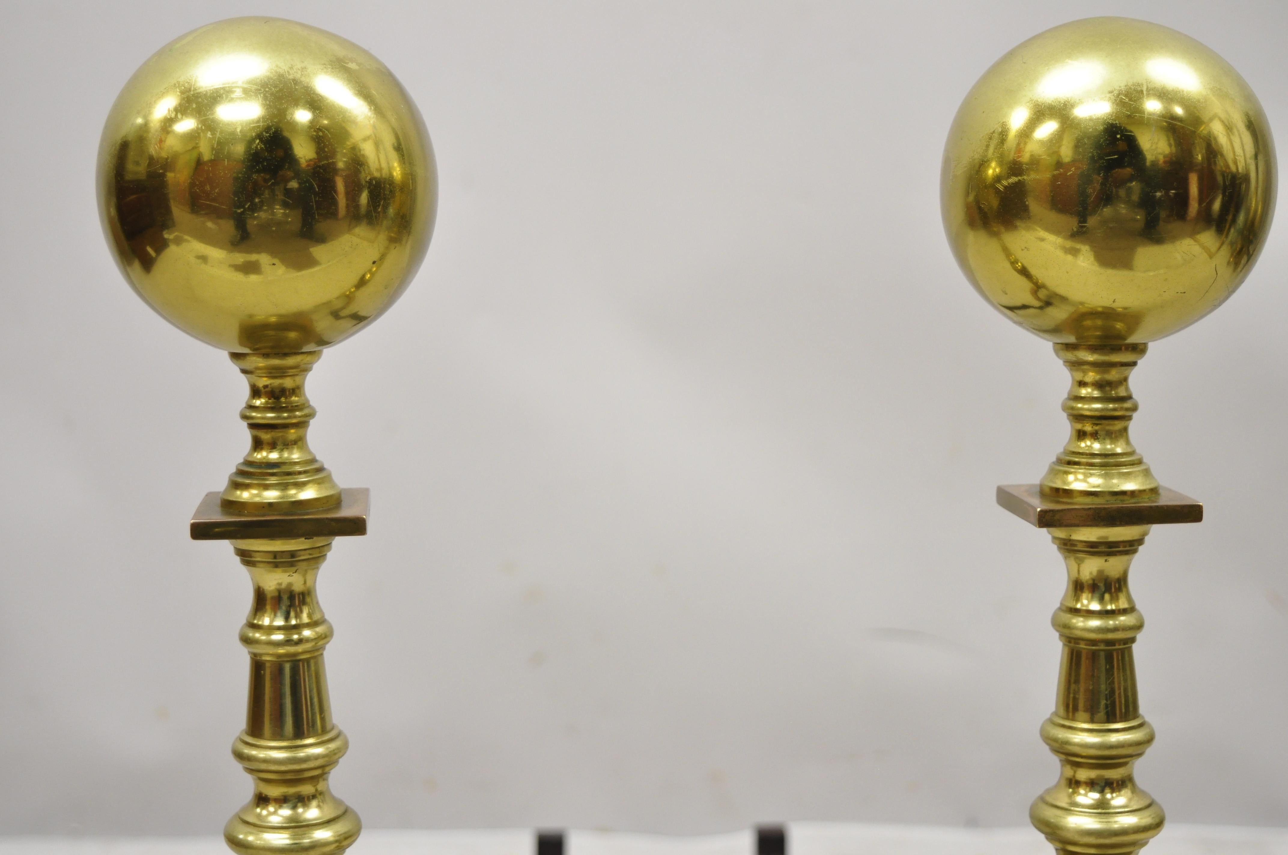 Antique brass cannonball spiral turned shaft cast iron andirons fireplace tools - a pair. Item features spiral turned shaft, large cannonball finials, branch Queen Anne style legs, very nice antique item, great style and form. Circa early to mid