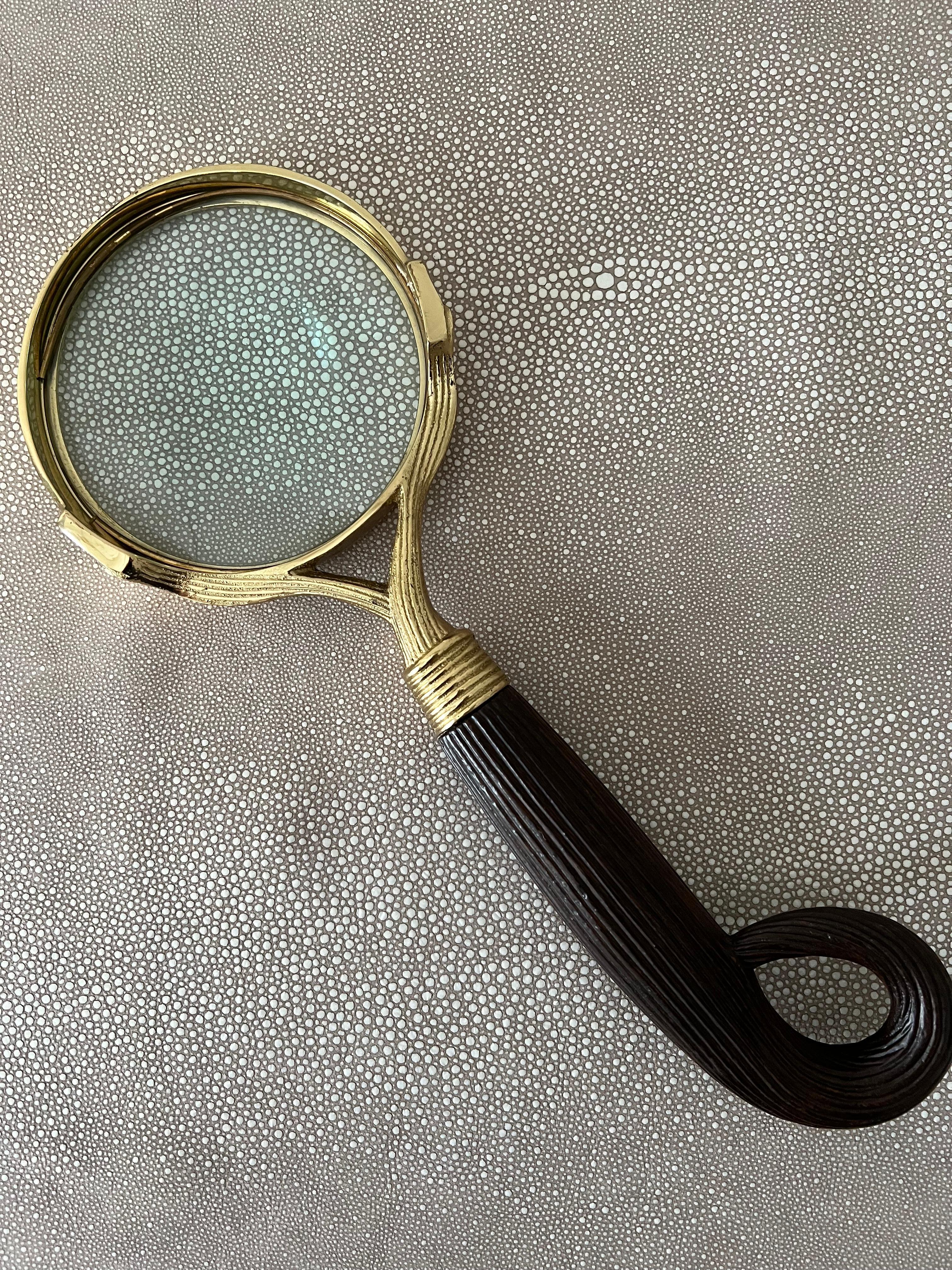 Brass magnifying glass with handle - a wonderfully functional, very large and heavy piece. The brass surround is quite nice and the handle could be wood, but also may be resin - either way, the piece is of substantial weight and quality - and works