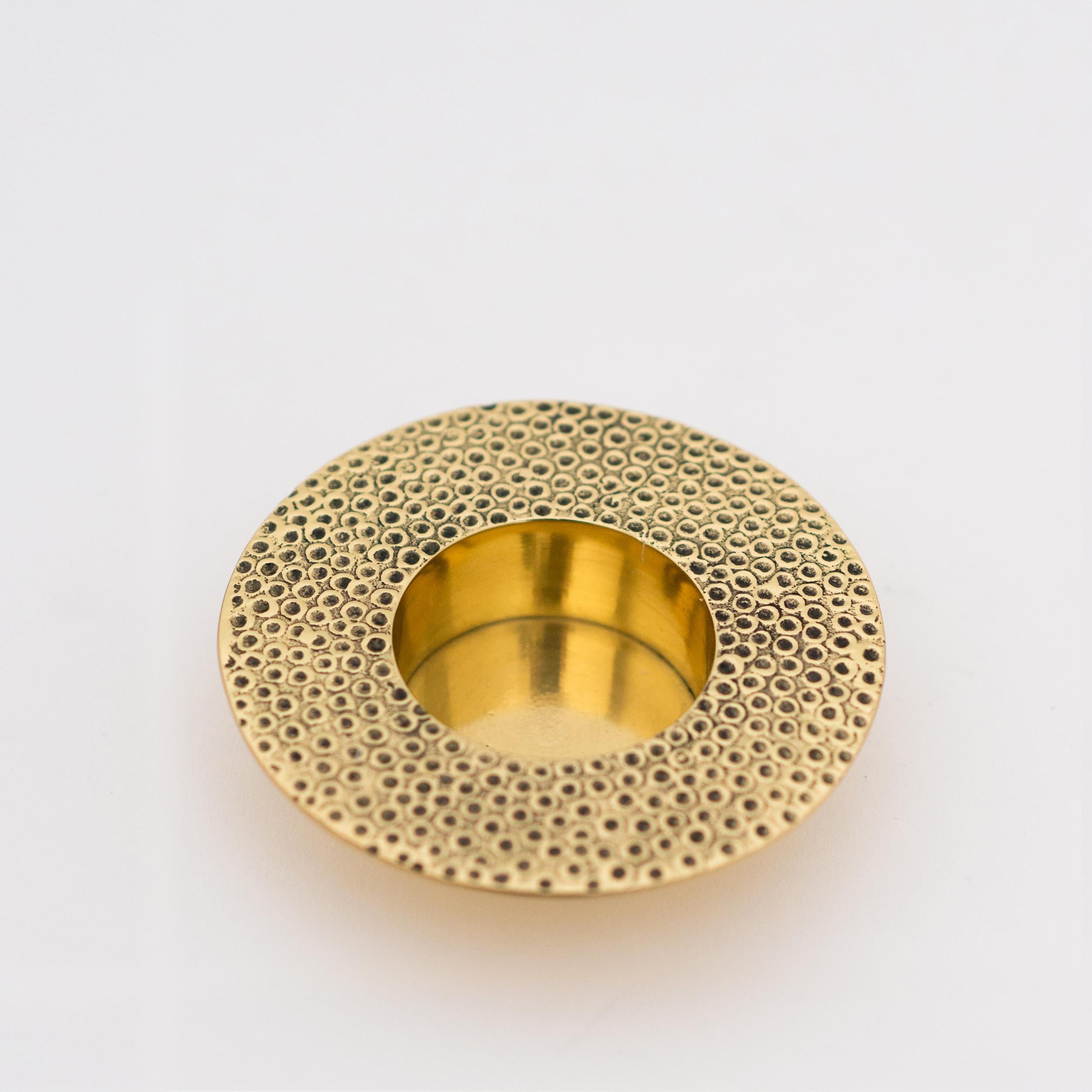 Each of those original brass tea light holders is handmade individually. Cast and textured using very traditional techniques, they are polished revealing the lustrous finish of this beautiful material.

Slight variations in the patina and polished