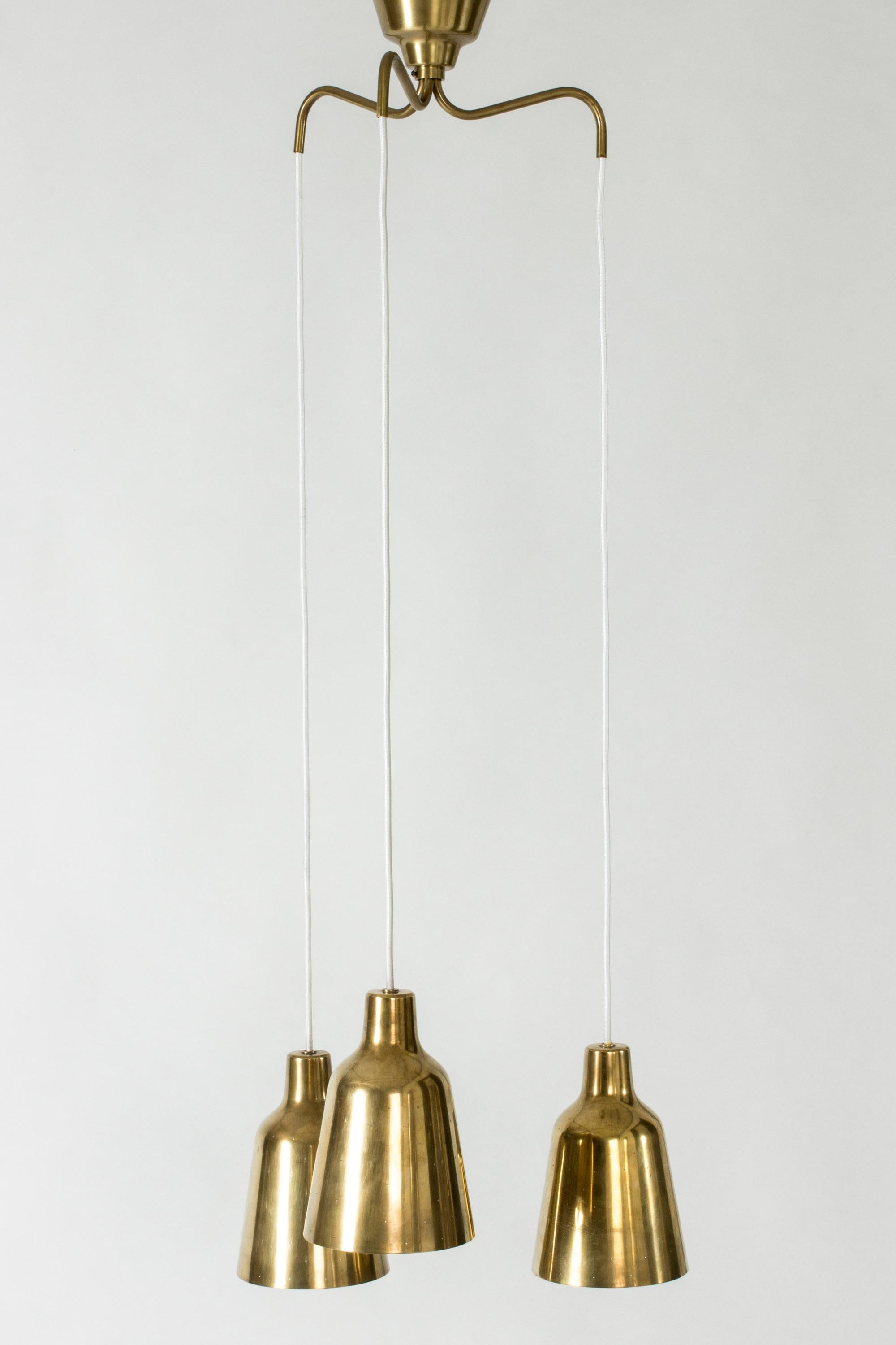 Elegant ceiling lamp by Hans-Agne Jakobsson, with three brass shades. The shades are perforated with small holes that shine warmly when lit.

Measures: Height of the cups 21 cm, diameter 14.5 cm.

Hans Bergström was the owner and creative