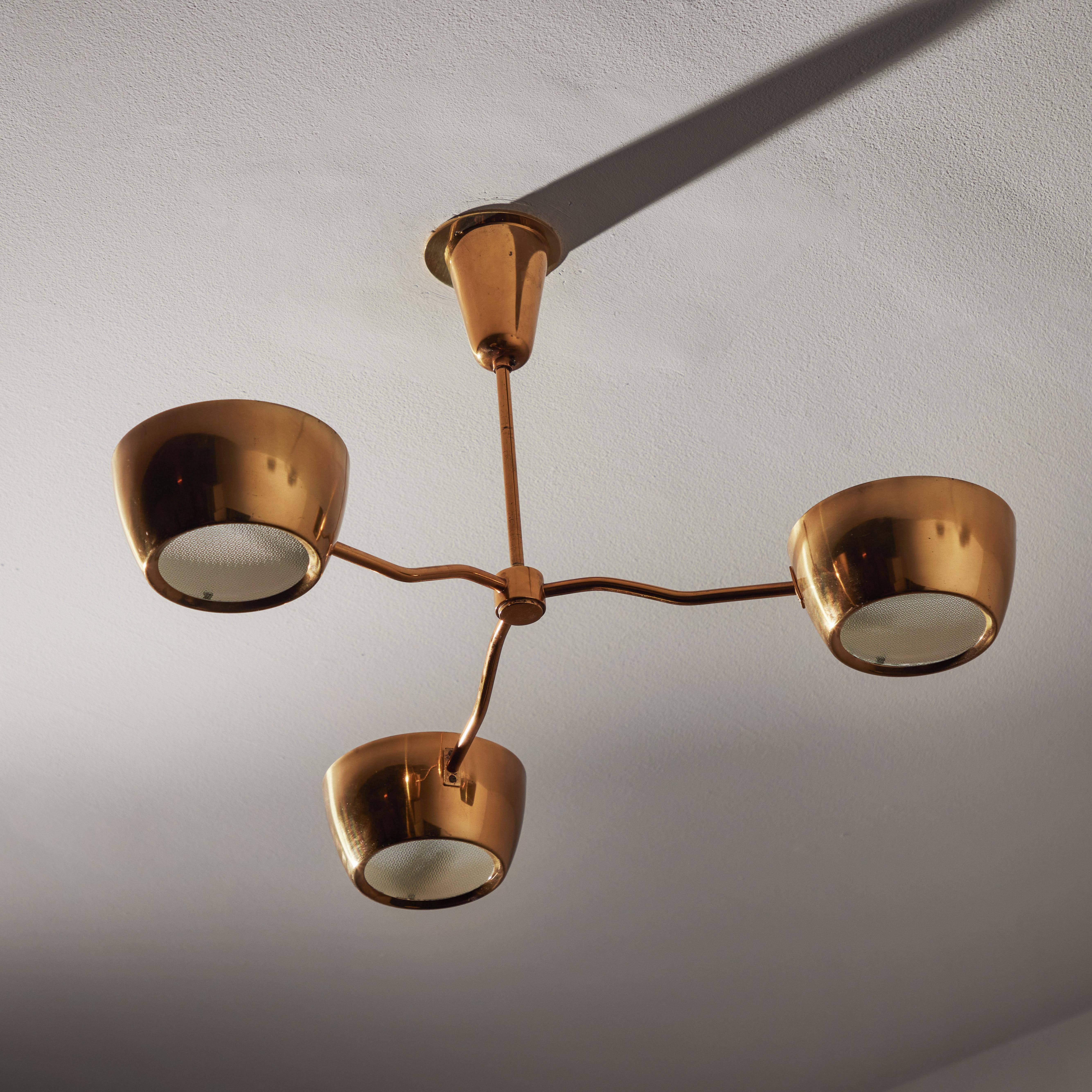 Brass Ceiling Light by Lumen. Designed and manufactured in Italy, circa the 1950's. All brass three-armed fixture. Each arm has one brass shade with textured glass diffusers set at the bottom. Original canopy with custom US backplate. Wired for the