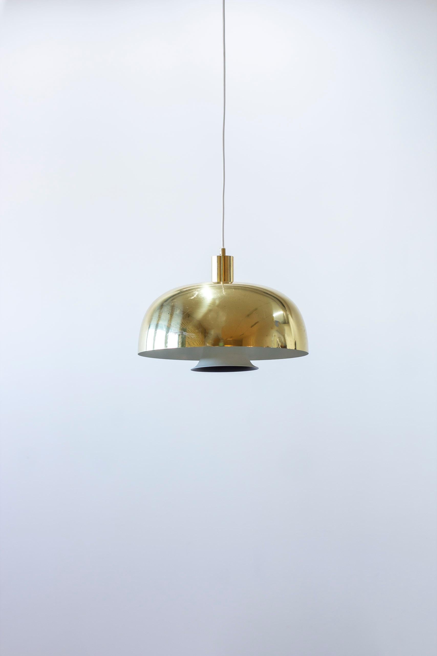 Lampada a sospensione da soffitto disegnata da Hans-Agne Jakobsson. Prodotto dalla sua azienda a Markaryd, in Svezia, durante gli anni '60. Realizzato in ottone lucido con diffusore e interno dipinti di bianco e nero. Buone condizioni vintage con