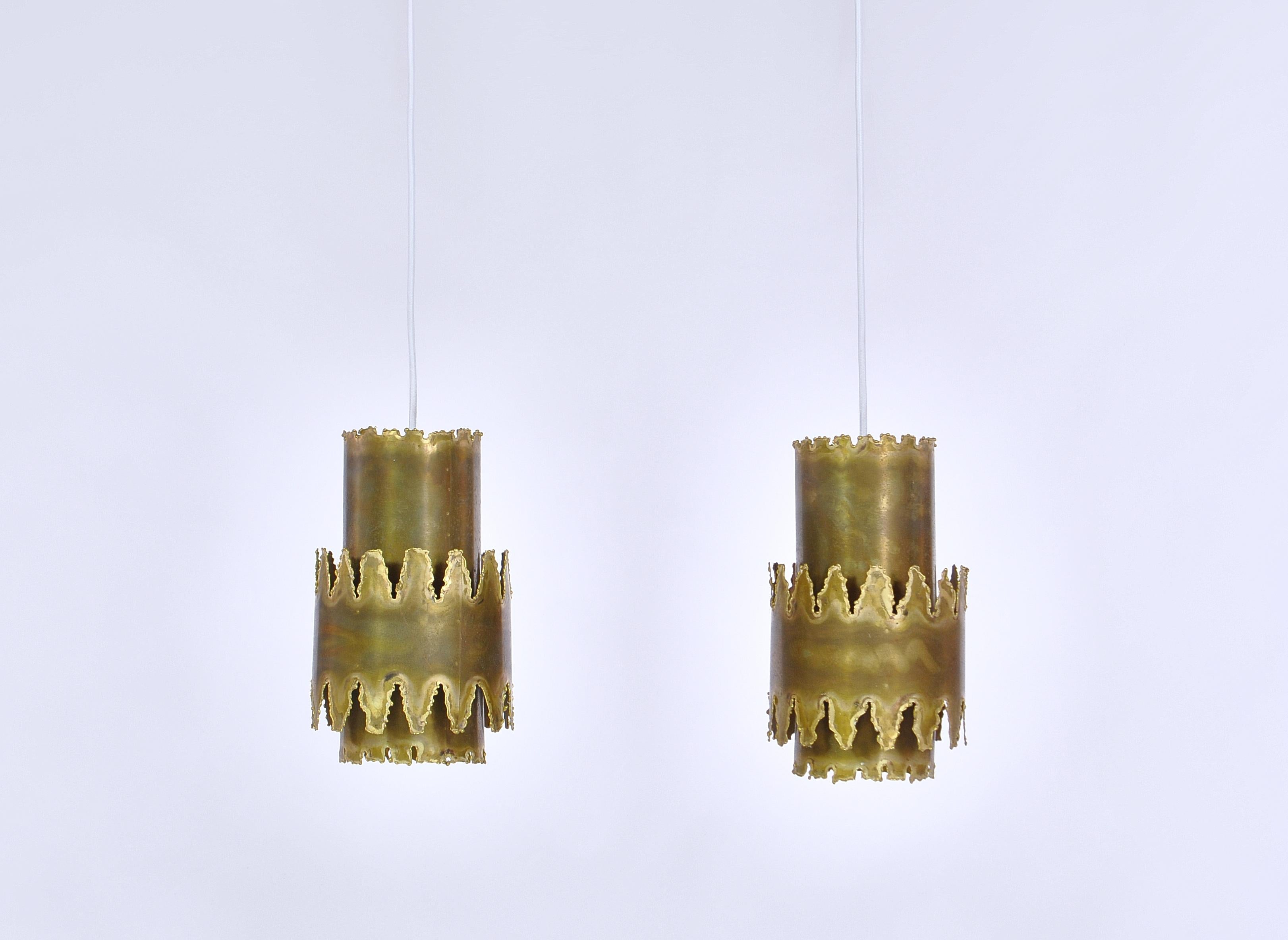 Stunning design by Danish designer Svend Aage Holm Sørensen from the 1960s. The pendants are made from solid acid cut brass cylinders and was produced by Holm Sorensen & co.´s own workshop in Denmark. The pendants is in good original condition and