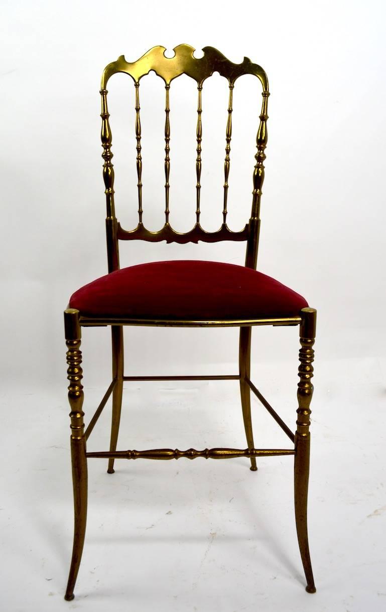 Elegant, chic and sophisticated side chair by Italian maker Charivari. Very fine, original condition, clean and ready to use. Patinated brass frame with red velvet seat (Seat H 19.5 inches).