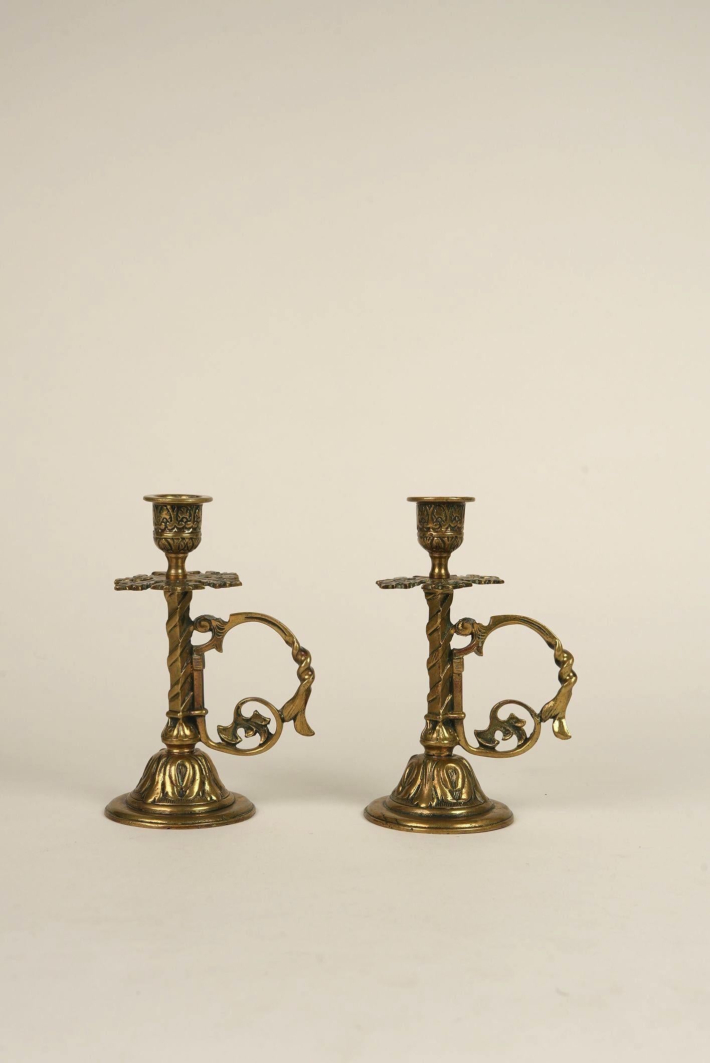 With its intricate scrollwork, acanthus leaf detailing, and graceful handle, this 1870s brass candle holder is a striking example of 19th-century European craftsmanship. What sets it apart is the sculptural quality—note the twisted column and ornate