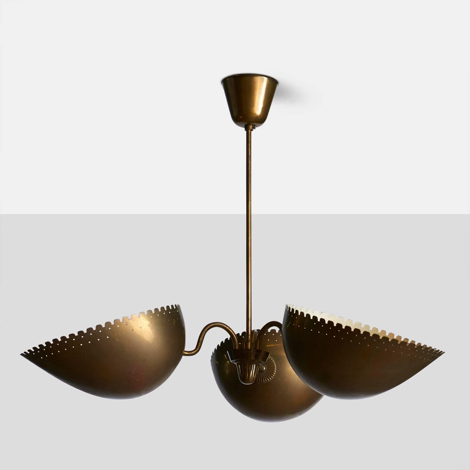 A wonderful aged brass pendant from Sweden by Bertil Brisborg for Bohlmarks. The lamp has three shades with serrated and perforated edges, facing upwards.
The lamp is marked by Bohlmarks,
Sweden, circa 1940s.