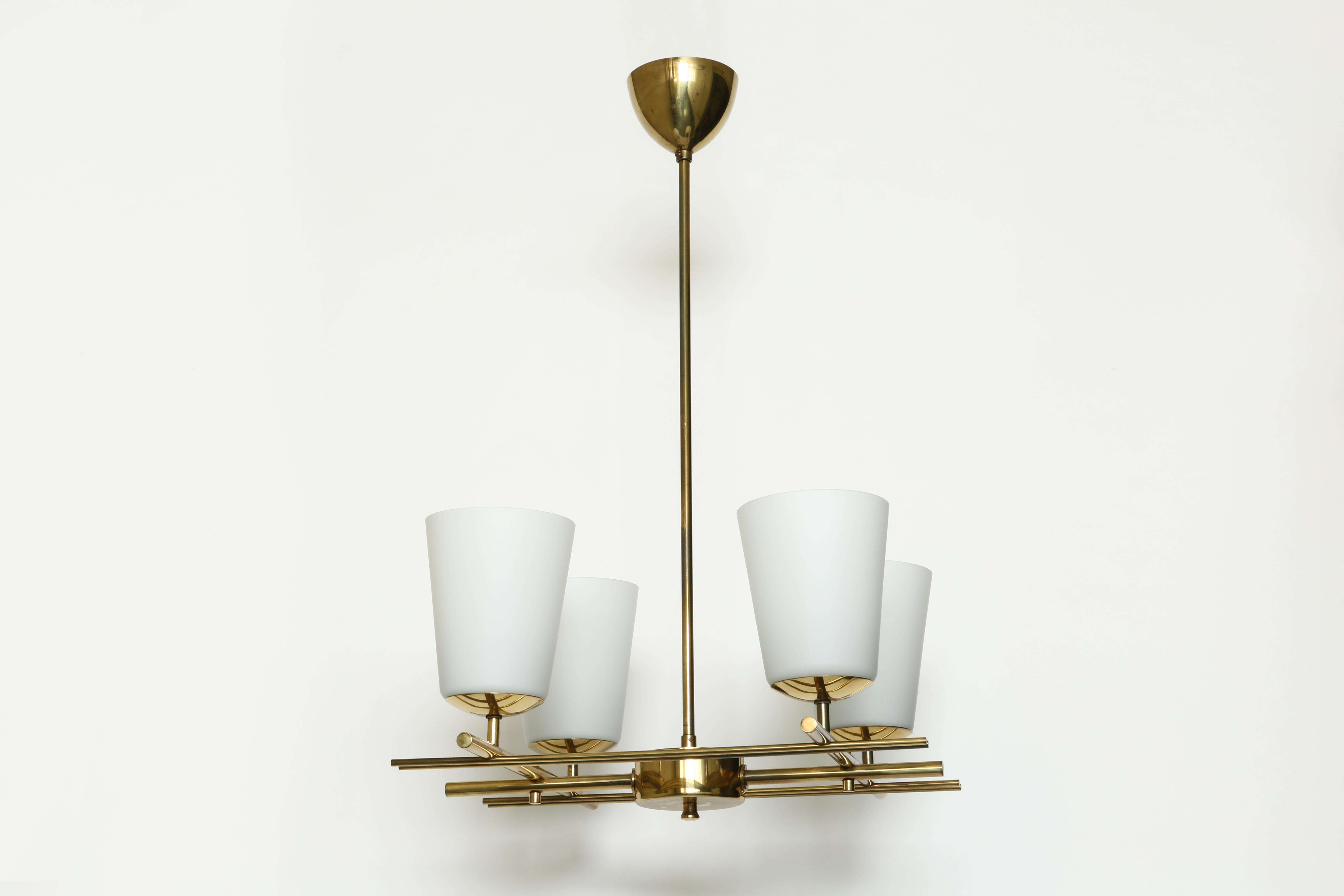 Brass chandelier by Itsu.
Four matte opaline glass bells and brass.
Finland, 1960s.
Model ER 162.