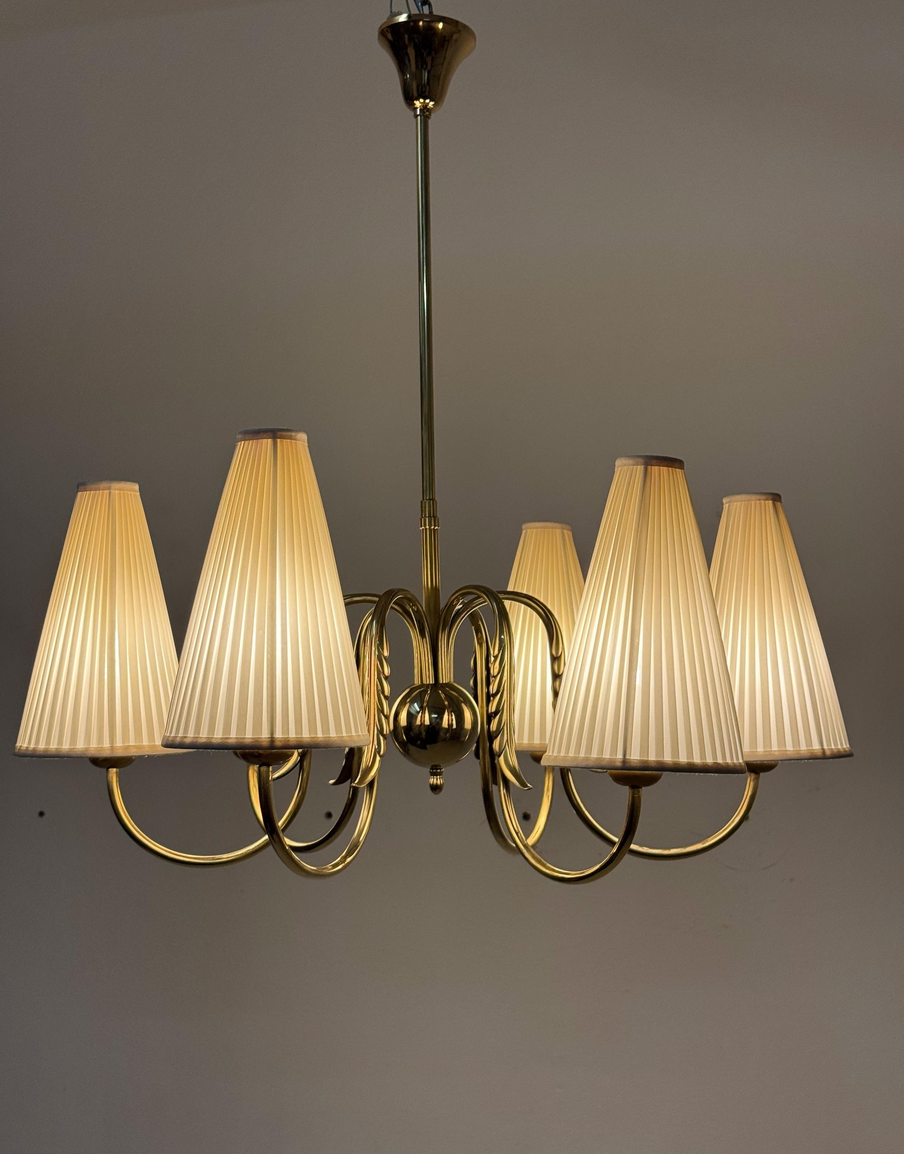 Brass frame with six arms fitted with E27 sockets each with silk shades. Designed by Josef Frank in the 1930s for J.T. Kalmar produced in the 1940s. 
The chandelier is fully restored with new european wire, sockets and shades (another shade option