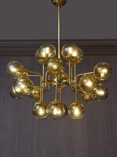 Brass chandelier by Studio Glustin