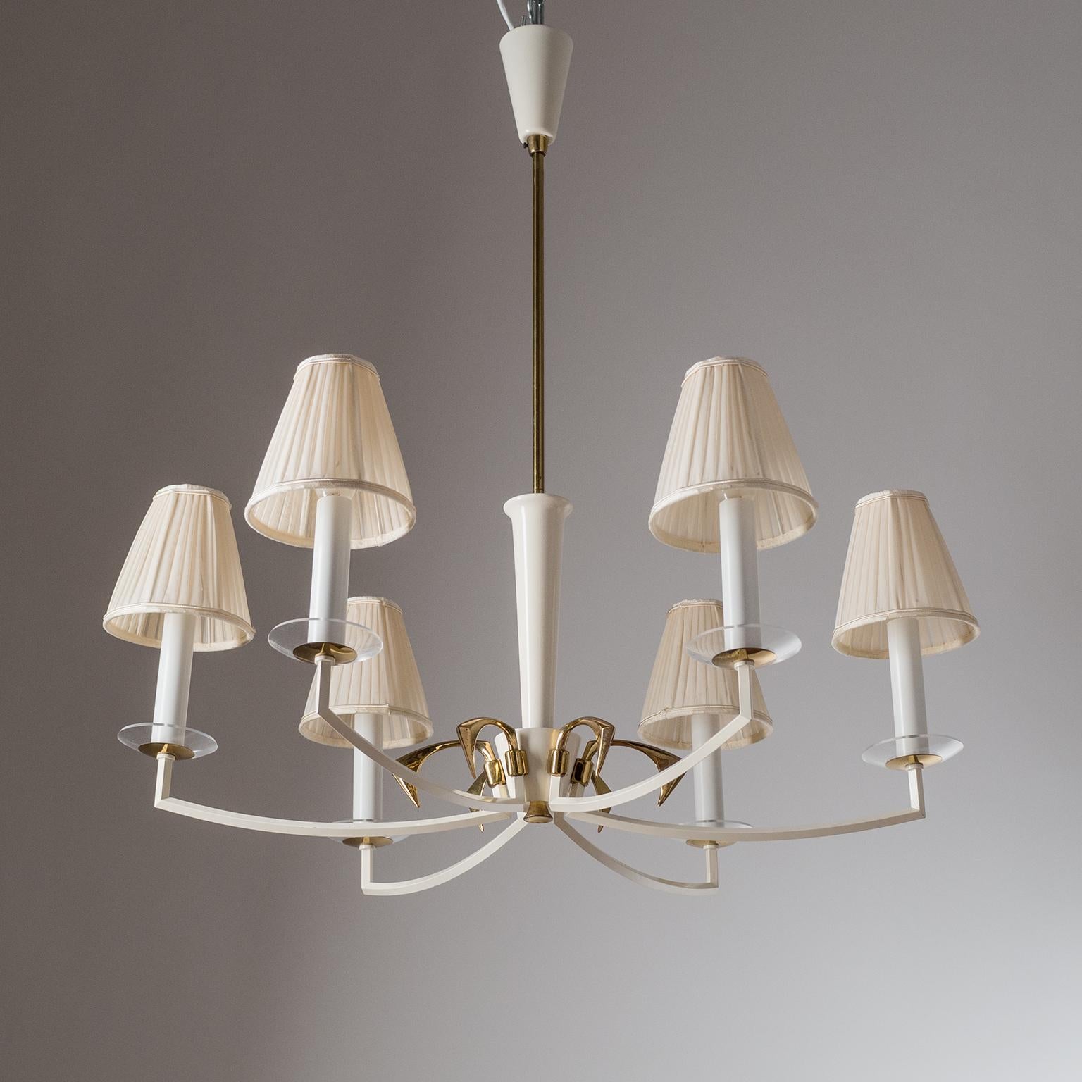 Rare brass chandelier by Vereinigte Werkstätten, circa 1960. The six brass arms have a rare angular shape and are enameled in off-white, as are the canopy and the wooden centerpiece on the stem. Very good original condition with minor patina and new