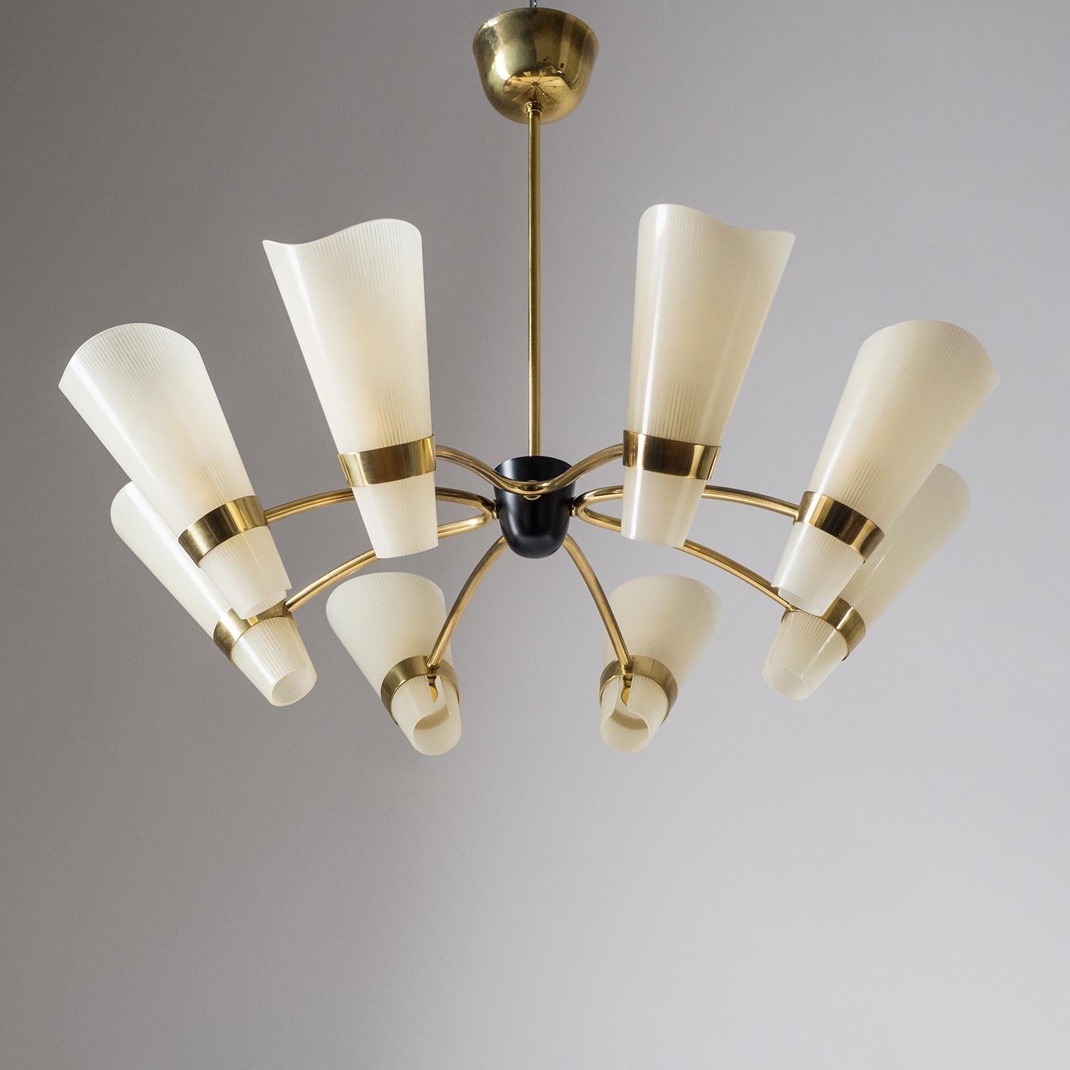 Lovely eight-arm brass chandelier from the late 1950s or early 1960s. The glass diffusers are enameled in ivory with a pin-stripe pattern and have a satin finish on the inside. Very good original condition with a light patina on the brass. Eight