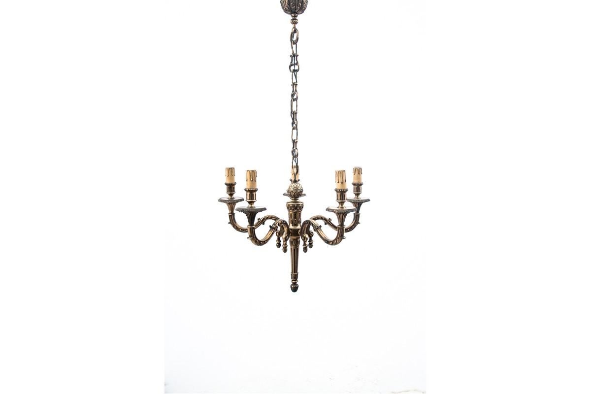 A chandelier made of brass. Made in France in the begining of 20th century circa 1920s. Very good condition, no damage. Working condition electric wires

Dimensions: height 89 cm / diameter. 50 cm.

