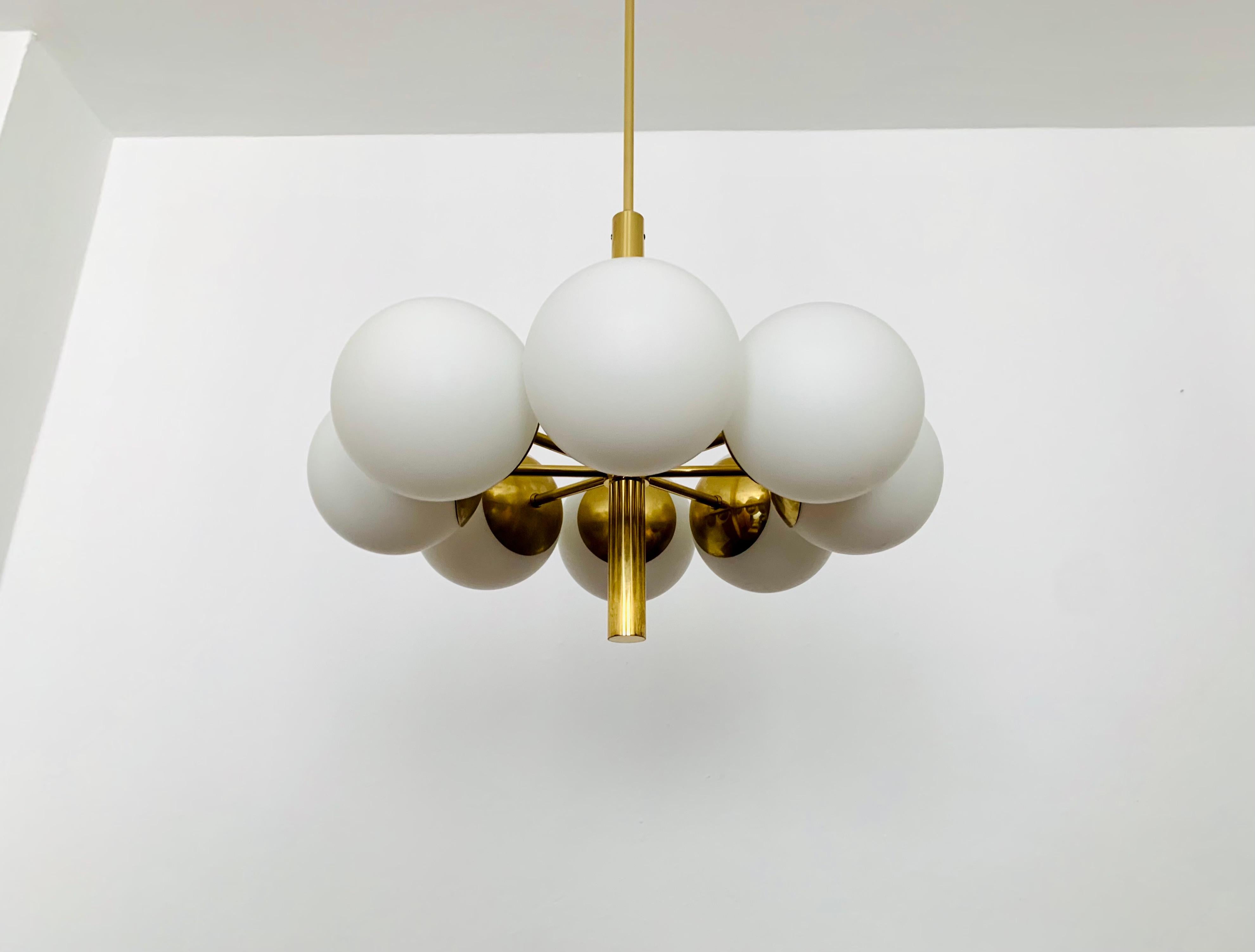 Wonderful golden Sputnik chandelier from the 1960s.
The opal glass lampshades spread a cozy light.
The lamp has a very high quality finish.
Very contemporary design with a fantastic look.

Manufacturer: Kaiser Leuchten

Condition:

Very good vintage