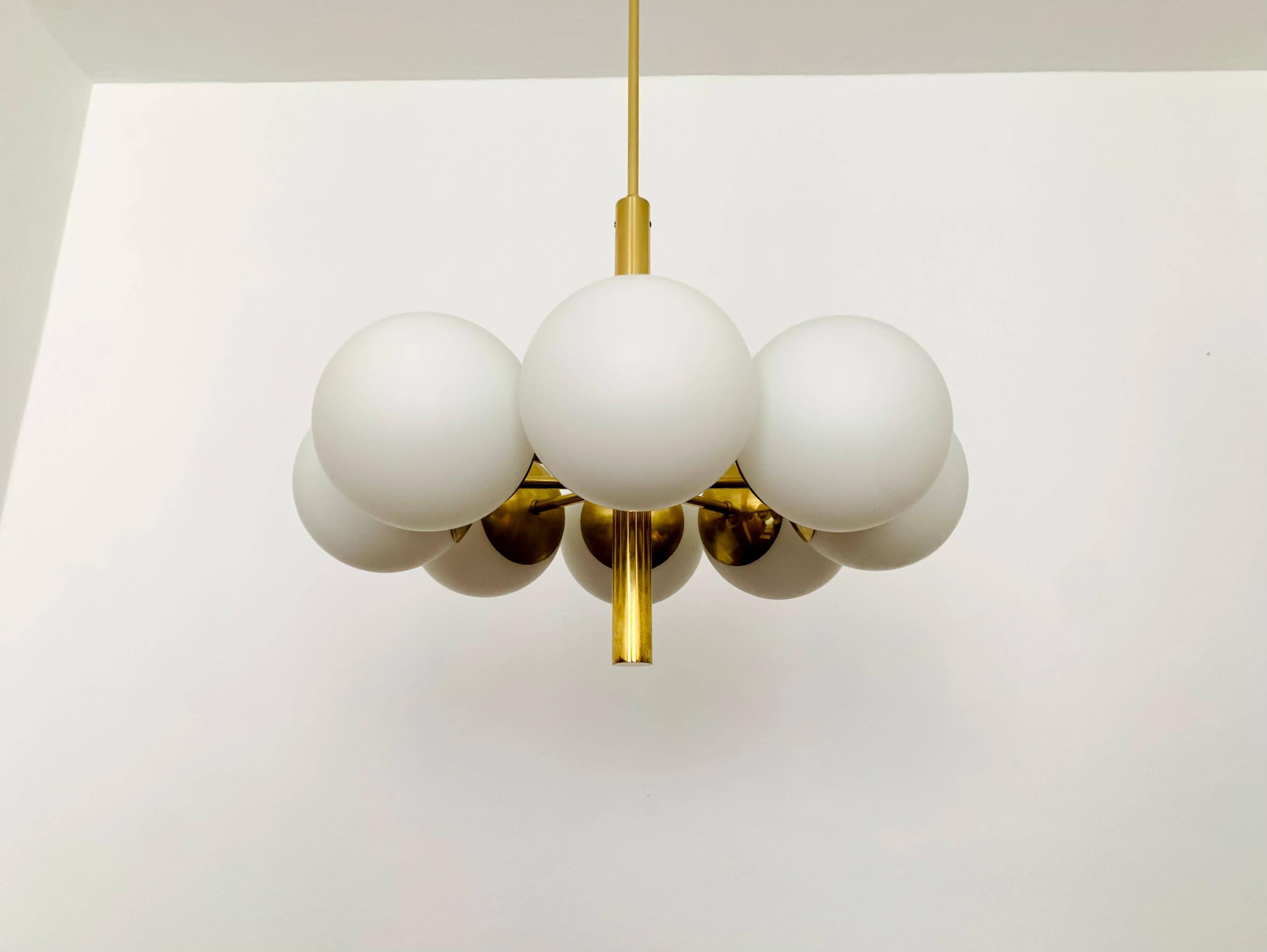 Wonderful gold Sputnik chandelier from the 1960s.
The opal glass lampshades spread a cozy light.
The lamp is manufactured to a very high quality.
Very contemporary design with a fantastic look.

Manufacturer: Kaiser Leuchten

Condition:

Very good