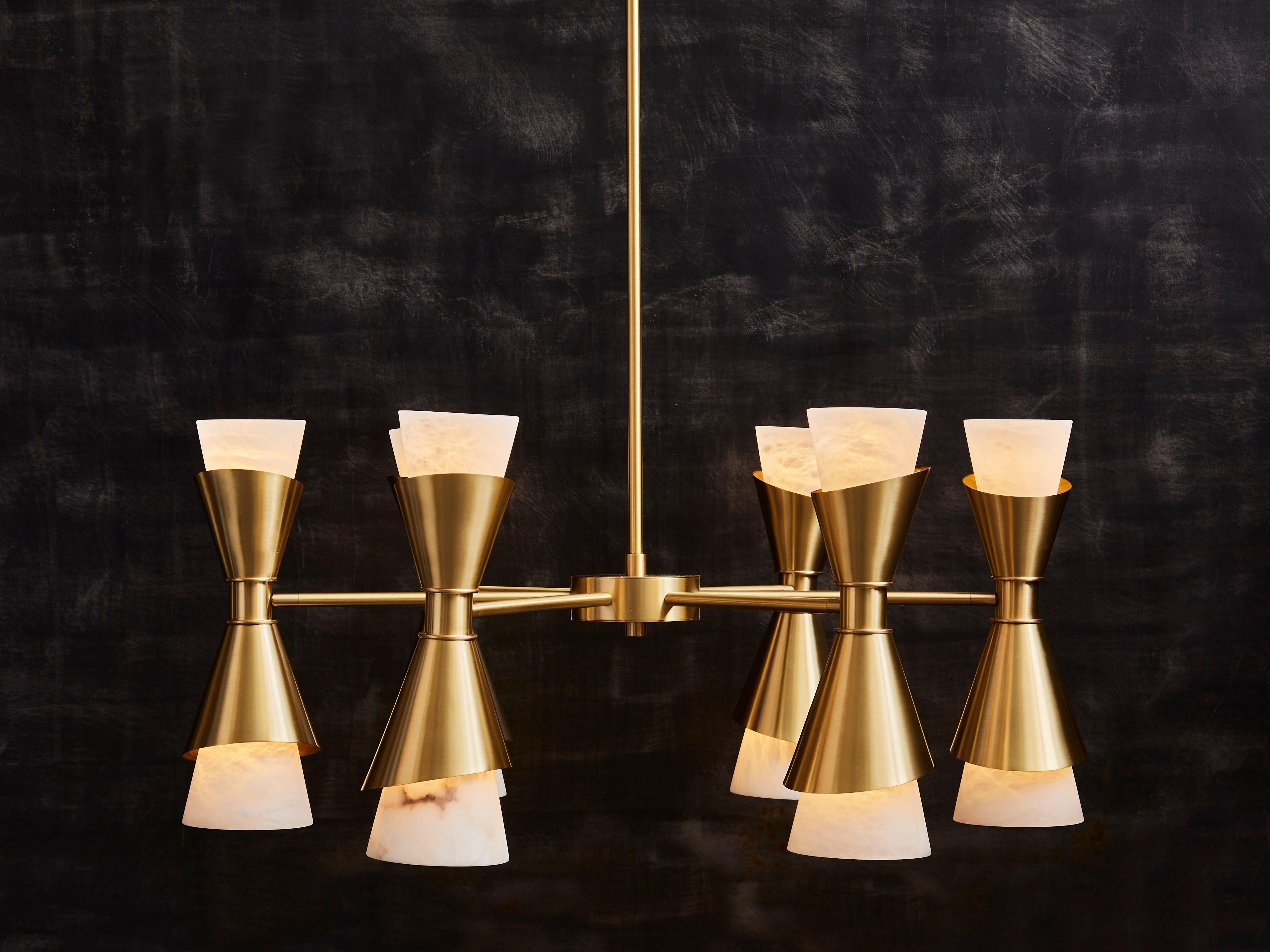 Traditional midcentury design brass chandelier updated with sharp bevels on the brass holders, and beautiful alabaster cones.