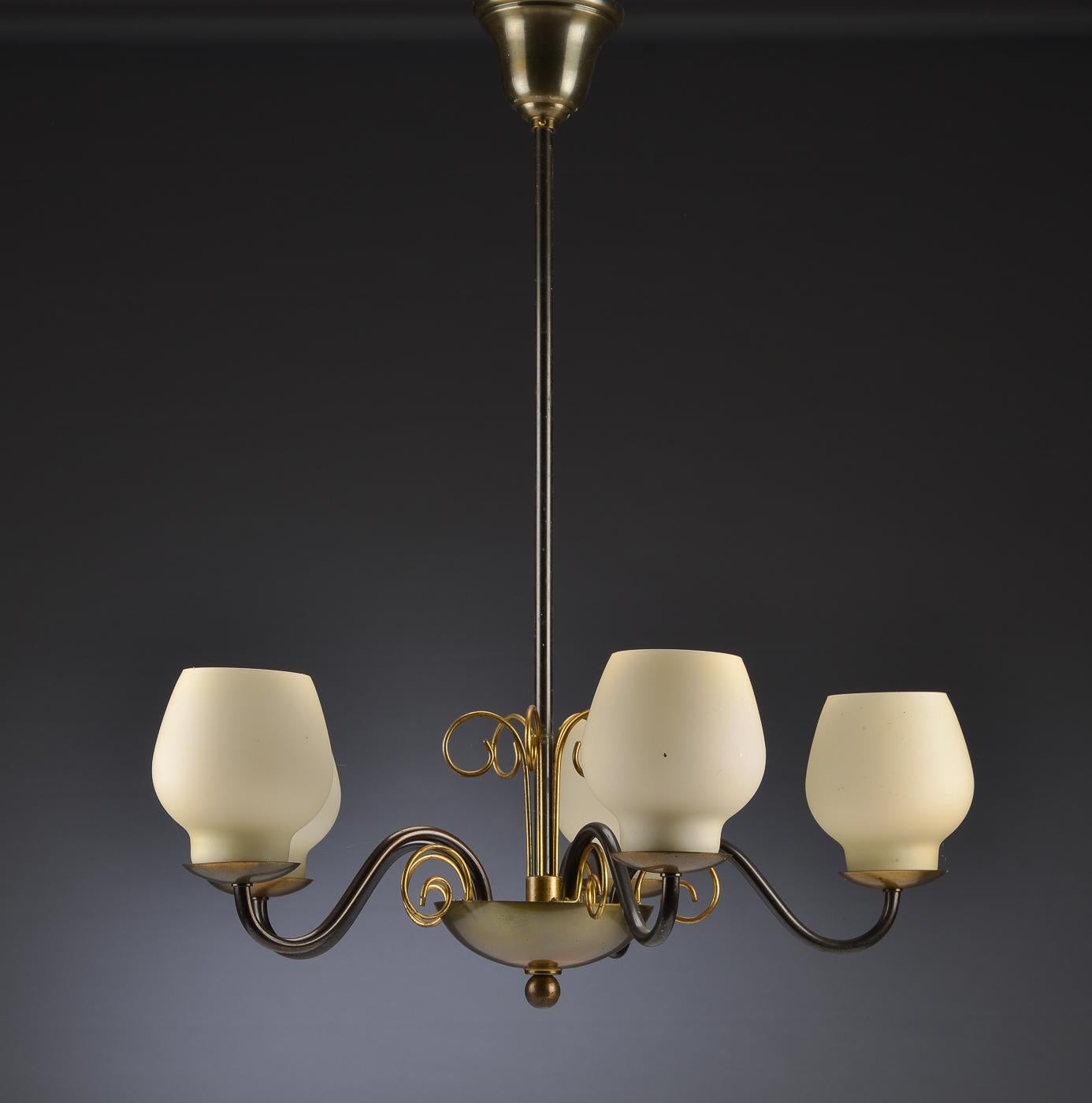 Brass construction with five opaline glass globes fitted with six E27 bulbs.
Designed by Bent Karlby for Lyfa in the 1950s in Denmark.
  