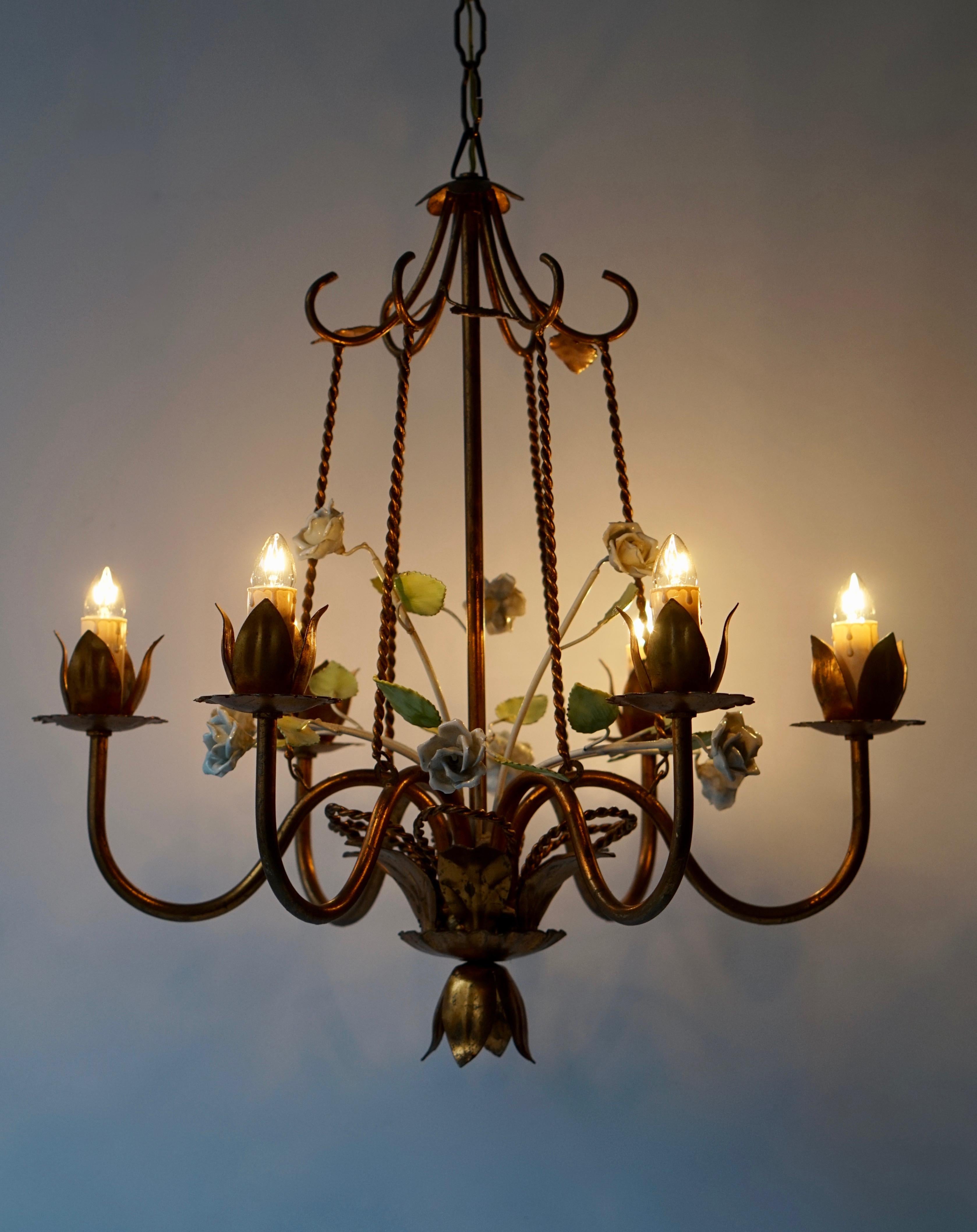 Brass white flower chandelier with six arms.

Diameter 50 cm.
Height fixture 52 cm.
Total height with the chain is 100 cm.