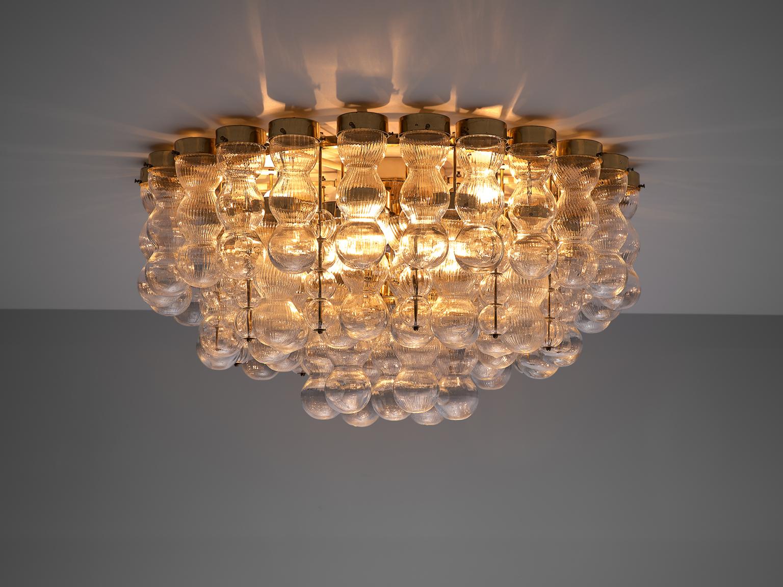 Large chandelier in brass with structured glass, Austria, 1960s.

The chandelier is equipped with six lights and a great amount of 55 glass shades. The shining brass details in combination with the structured glass spheres provides a beautiful