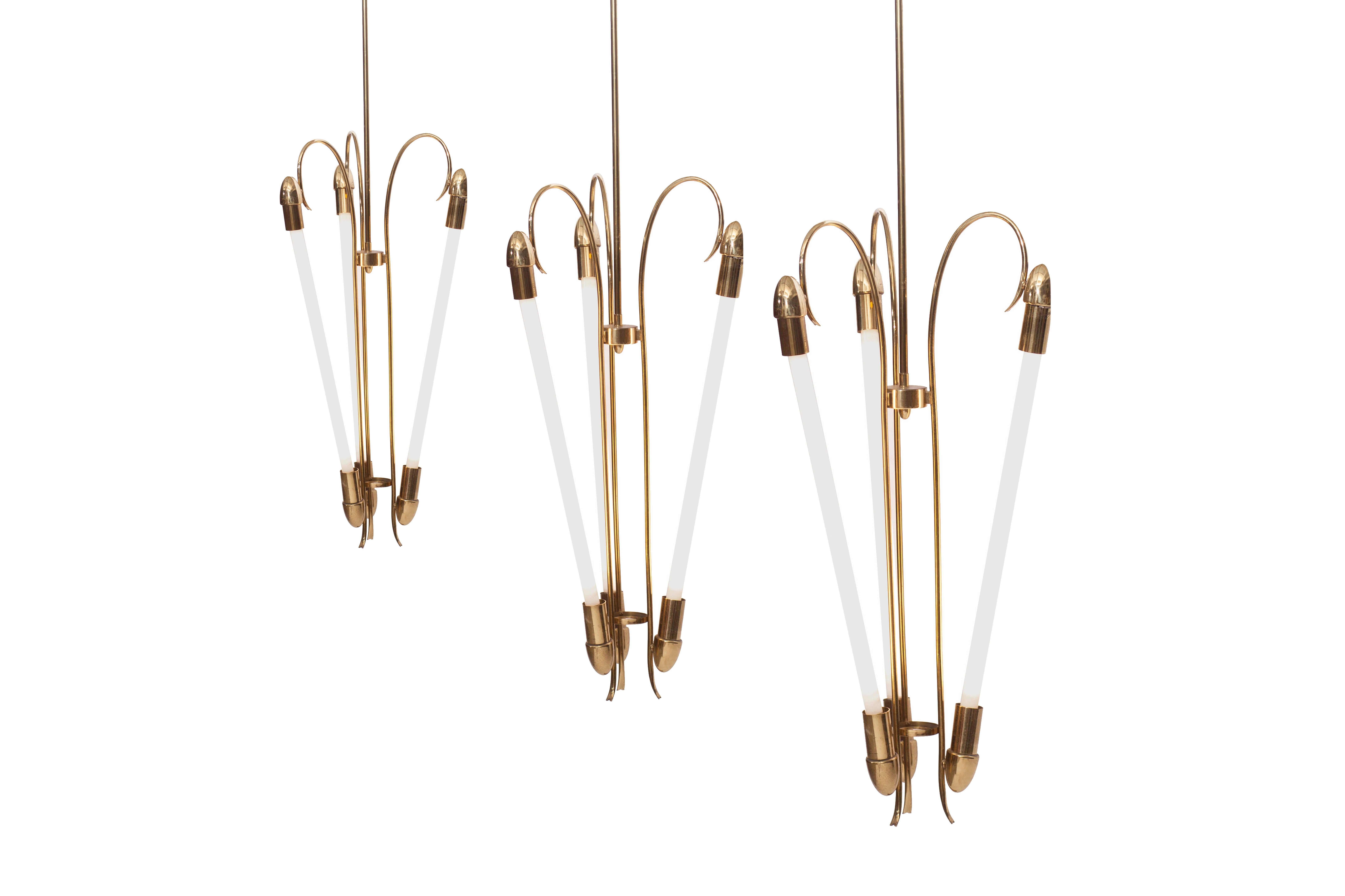 Regency brass chandelier by Kaiser & Co, made in Germany, circa the 1940s. 

Three fluorescent tube lights.

In the fashion of Art Deco transitioning into modern and Bauhaus.

Measures: H 200 cm, Ø 46 cm

We have three pieces available,