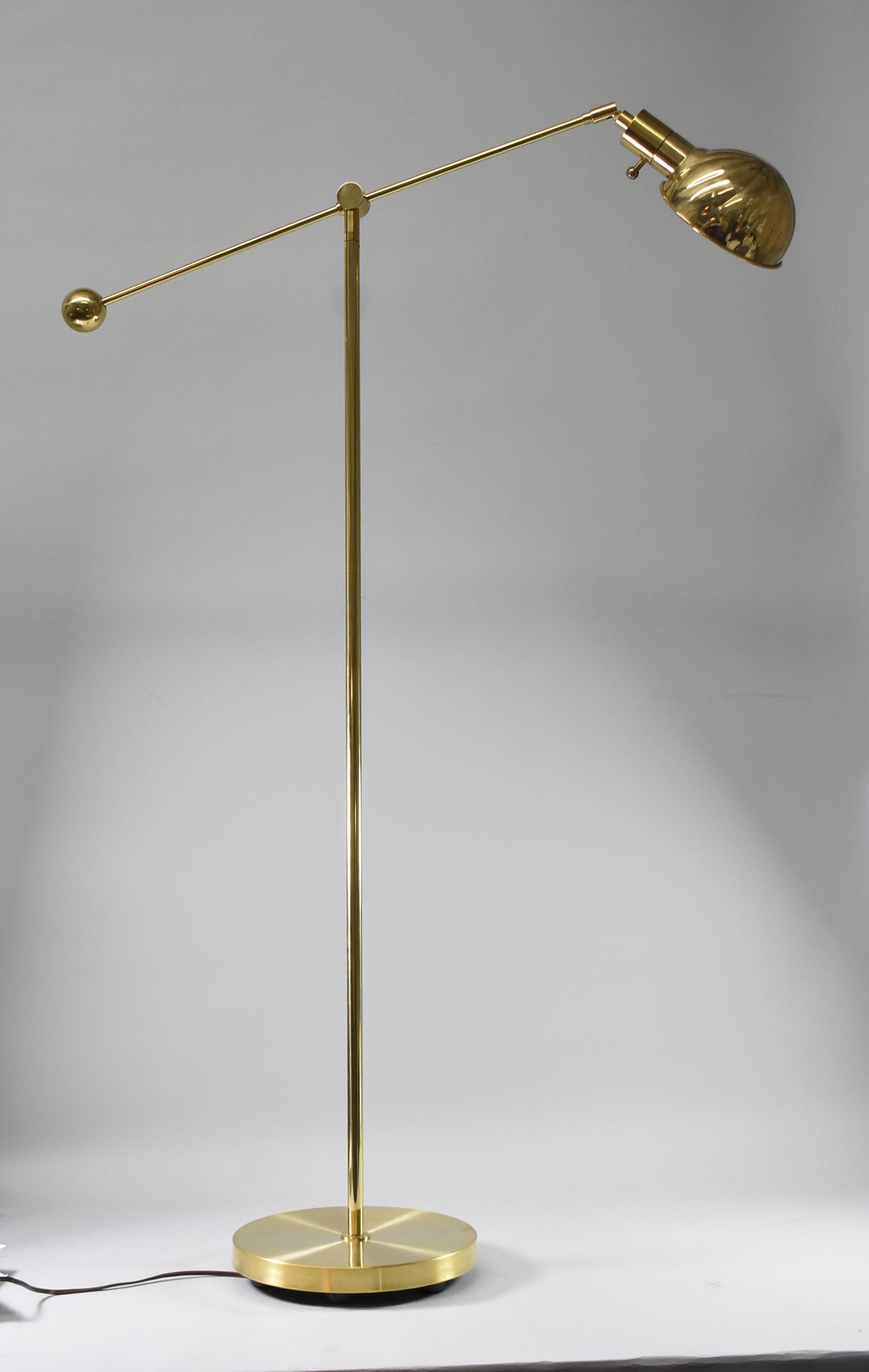 Brass Chapman cantilever floor lamp 1979. Counter-balanced cantilever brass floor lamp with shall design shade and integral switch. Cantilever arm sits atop tubular pole. Shade can be angled and rotated. Arm adjusts to different angles and swivels