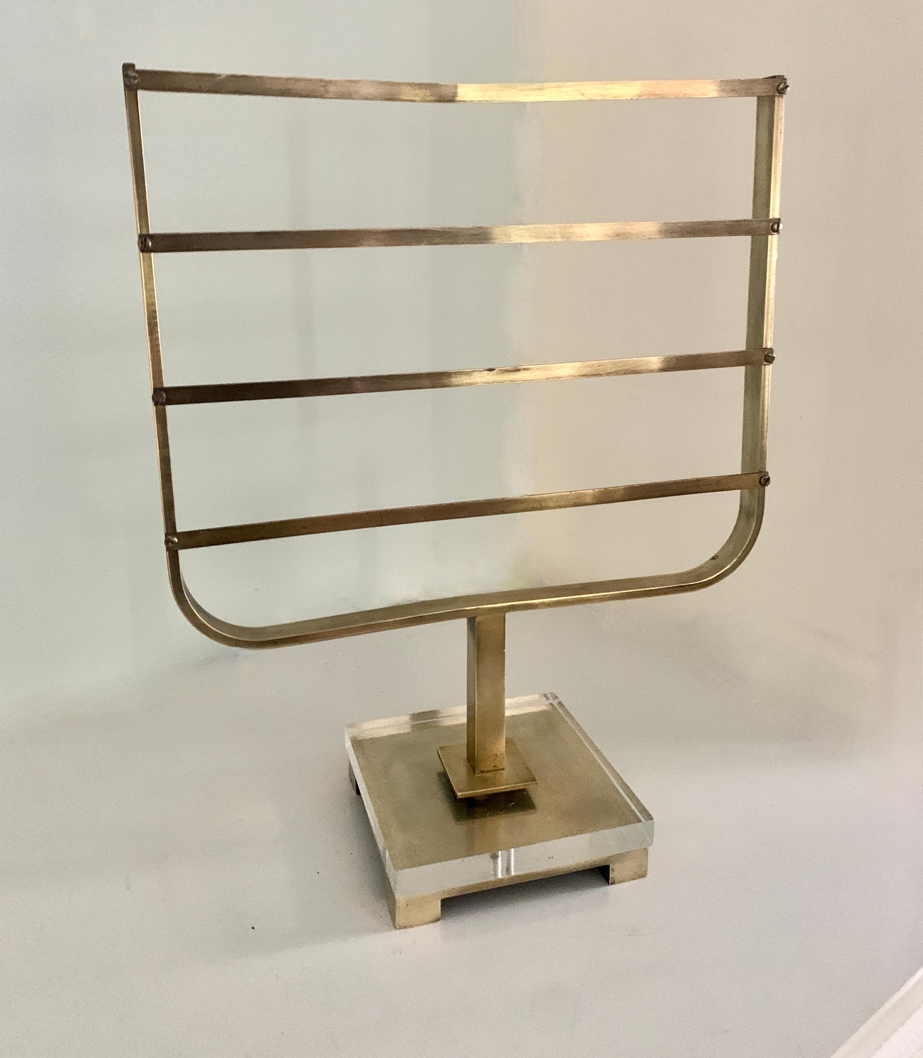 A Brass Jewelry or Scarf holder. The Base is acrylic and brass with ladder style holder that works for many items, from assorted jewelry, earrings, necklaces, scarves and ties. Reminiscent of other stands and mirrors by Charles Hollis Jones iconic