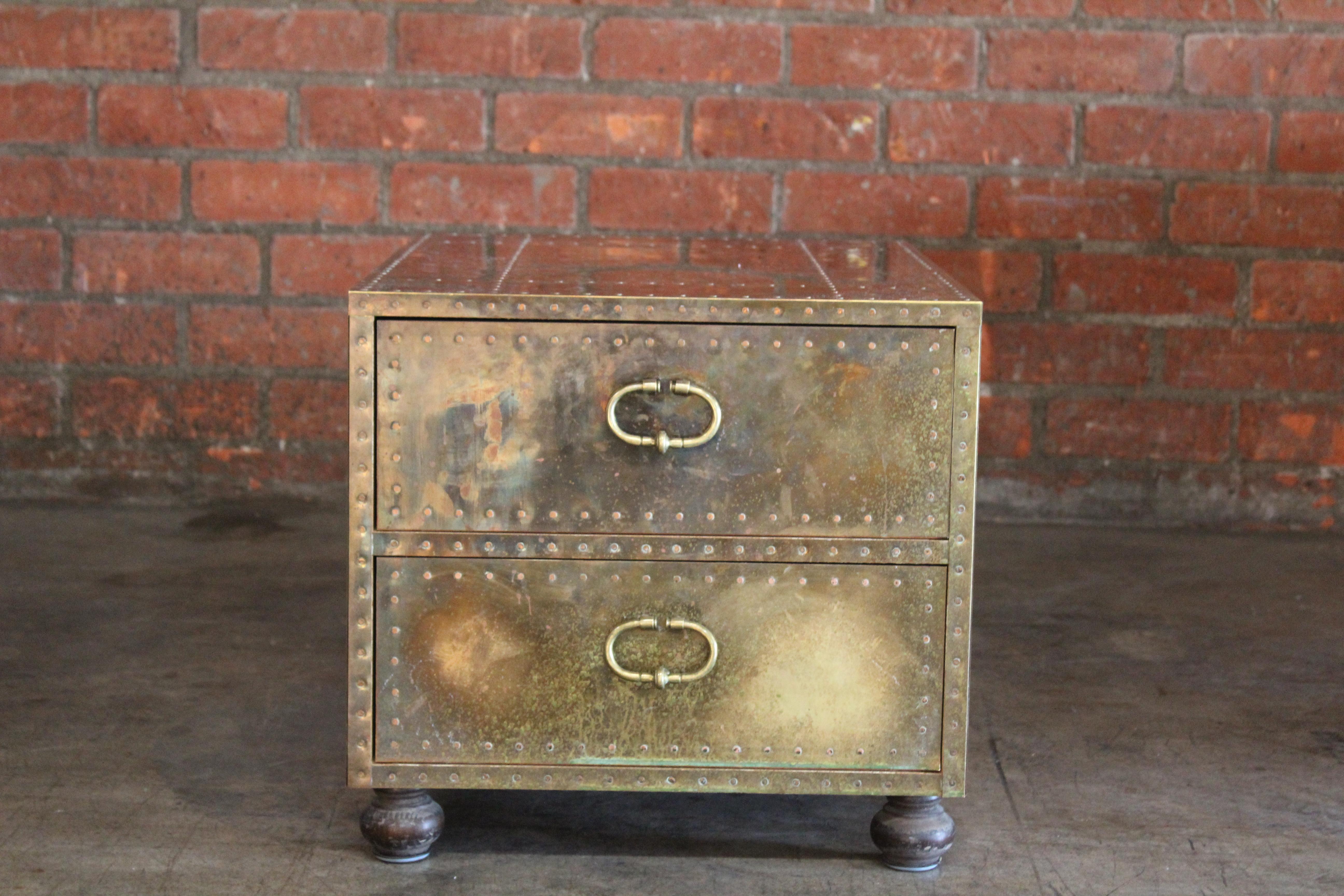 A vintage brass clad campaign chest with two drawers and solid walnut legs, made by Sarried LTD. Spain, 1970s. In good condition with a wonderfully aged patina.