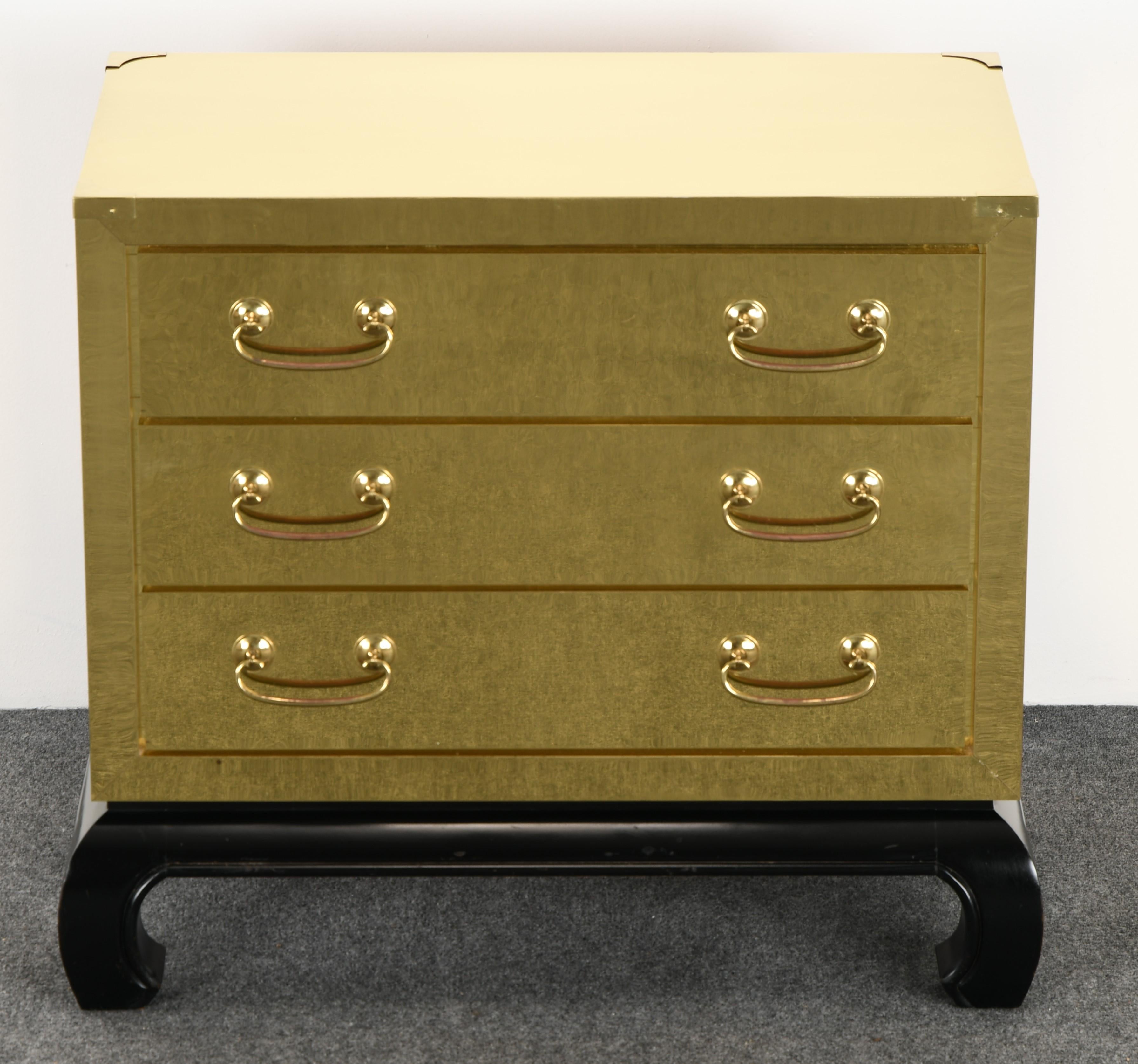 A brass-clad chest in the manner of Sarried Ltd, Spain, 1960s. This chest is in beautiful condition and structurally sound. Accented with a black painted scroll foot. The drawers pullout / pull-out smoothly. Some very minute dings as shown in images