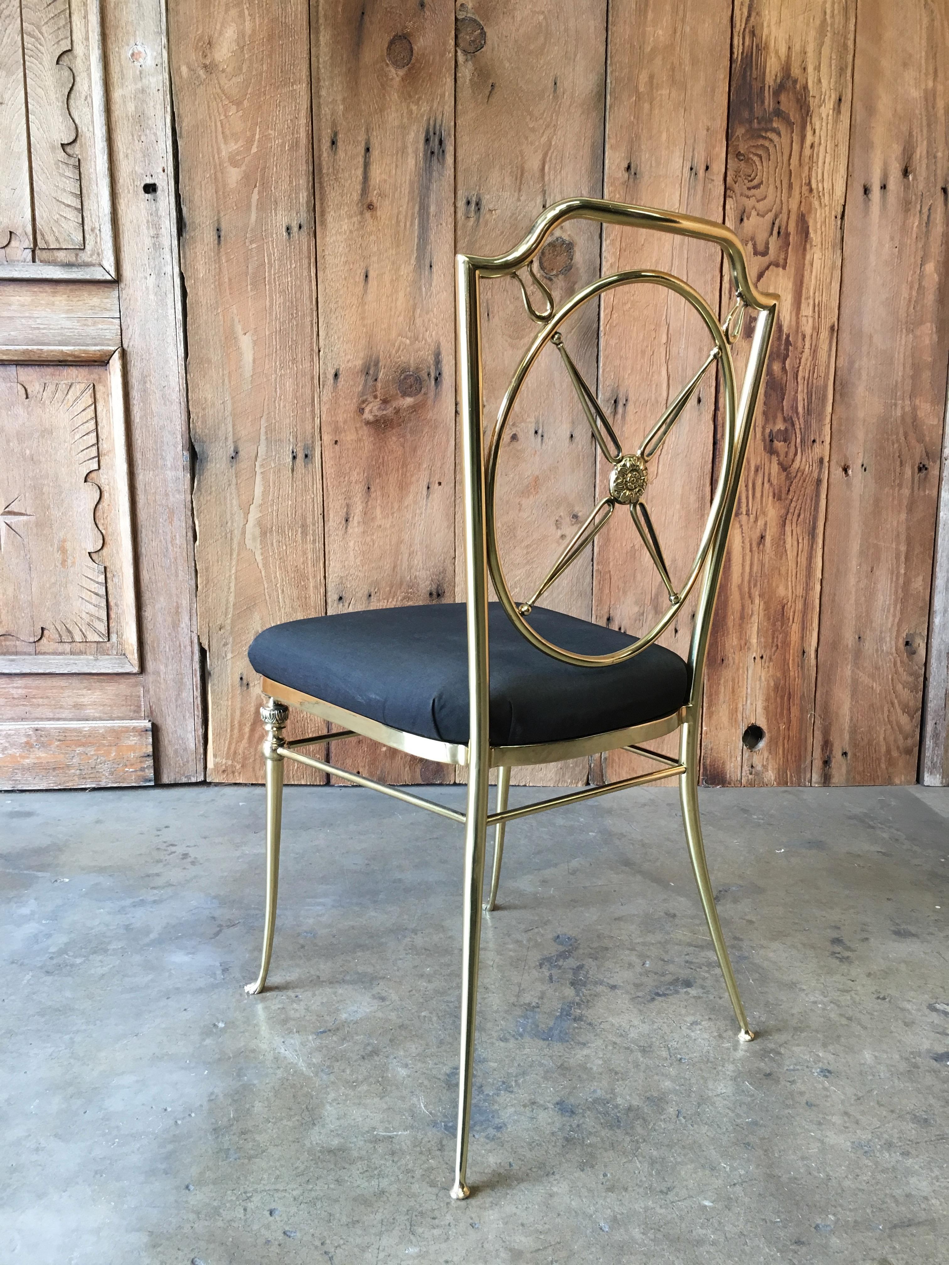 Brass accent chair with circled X-back and paw feet.