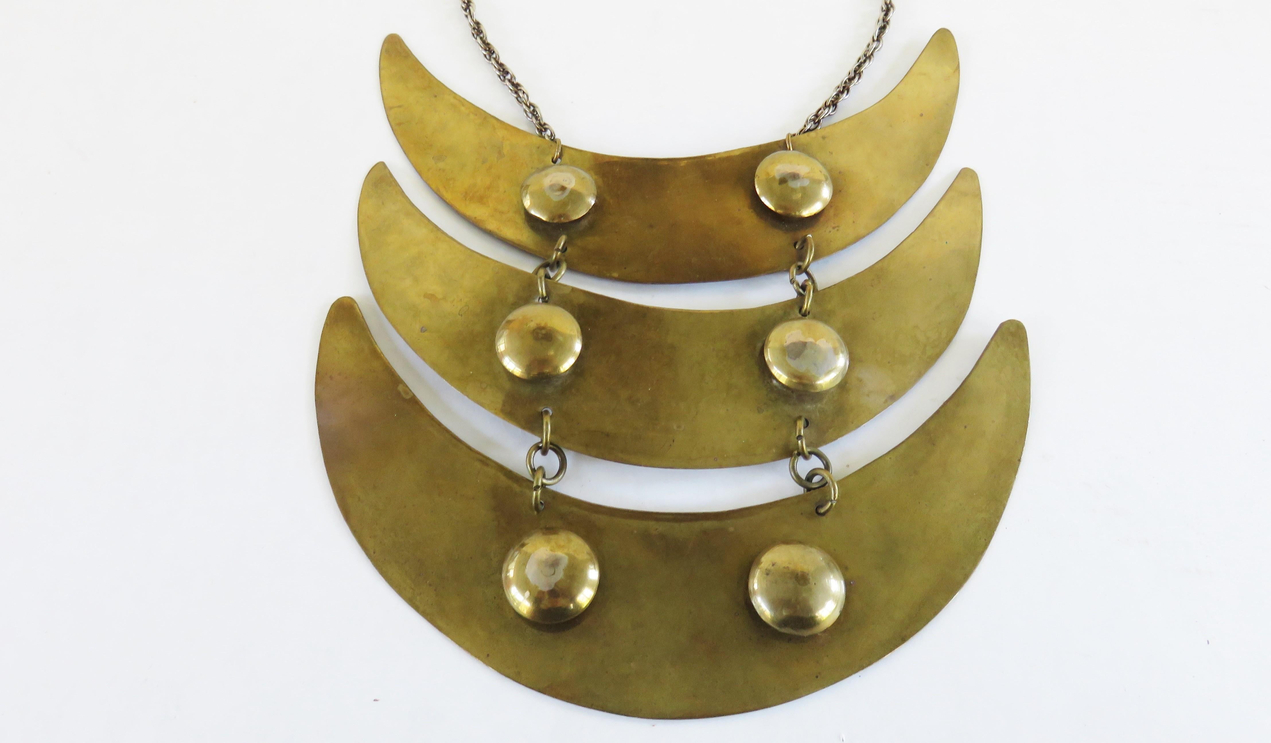 A fabulous golden brass choker collar with three crescent drops from a chain neck with a spring closure.  The crescents are joined with chains and there are 2  1