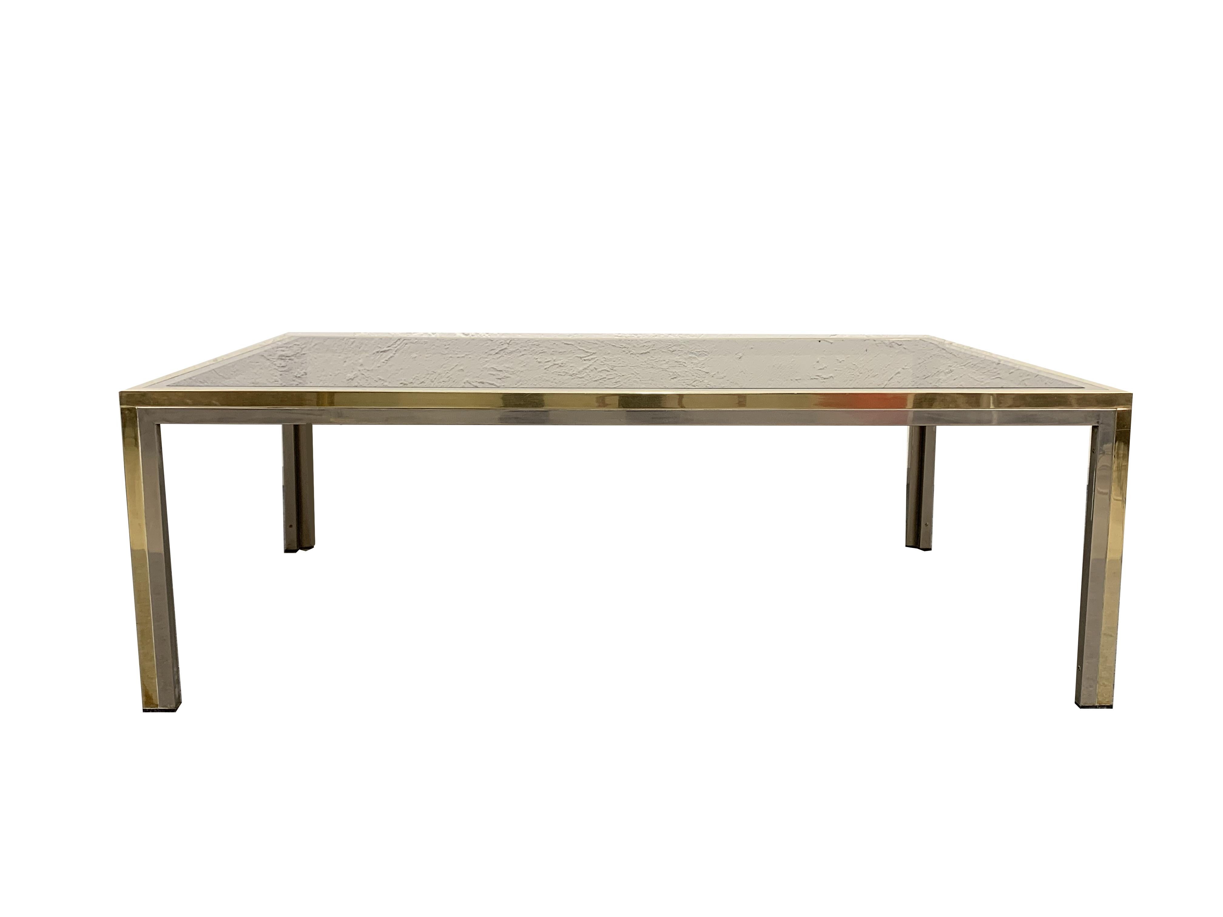 This iconic coffee table was designed in the style of Romeo Rega, one of the few 1970s-era Italian designers that are associated with a combination of modernism and glamour in their furniture creations.

Like most of Rega's production, this