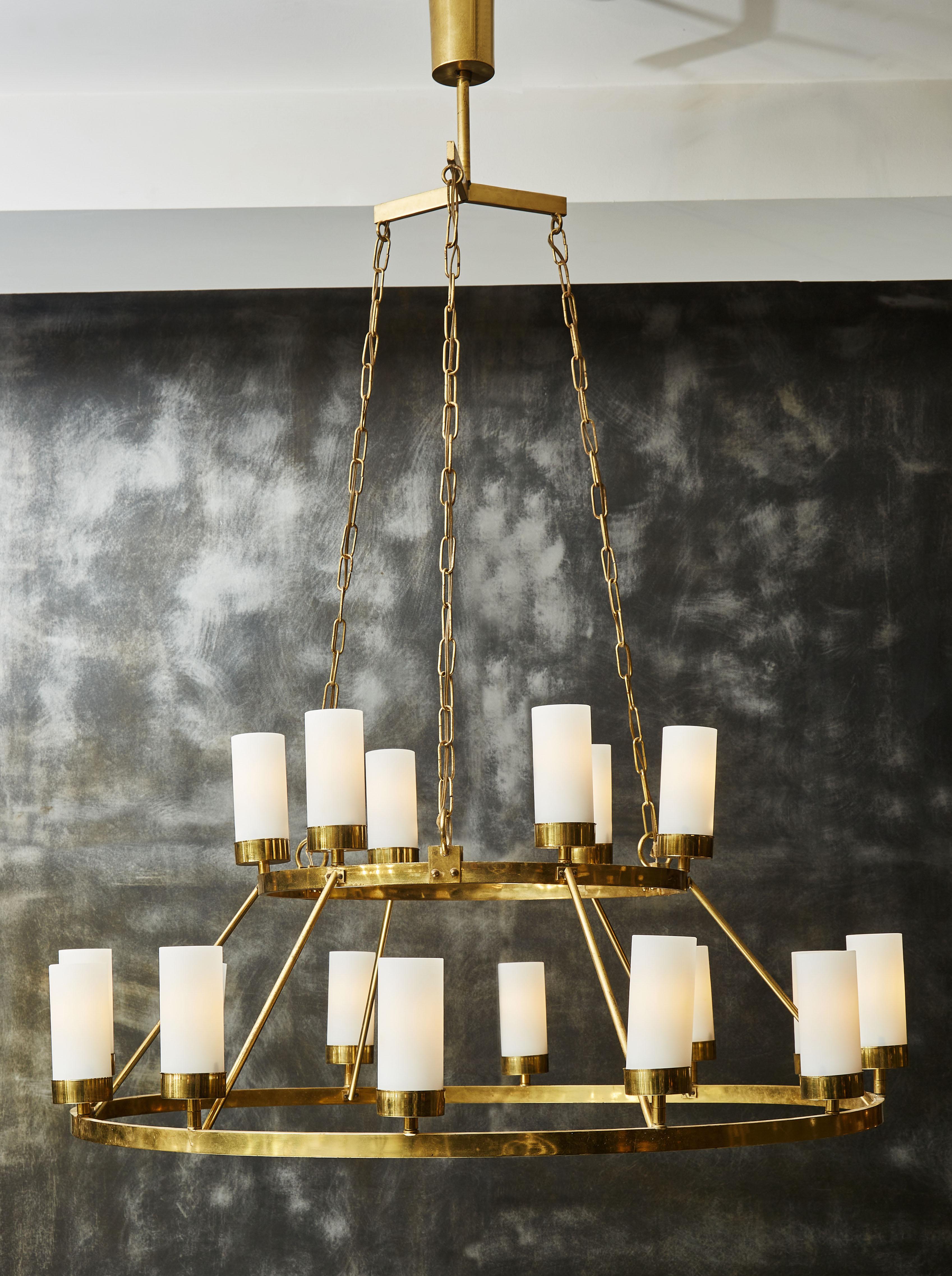 1960s Italian chandelier made of two brass hoops hanged by chains, on which are eighteen lights inside opaline tubes.

Chains can be shortened.