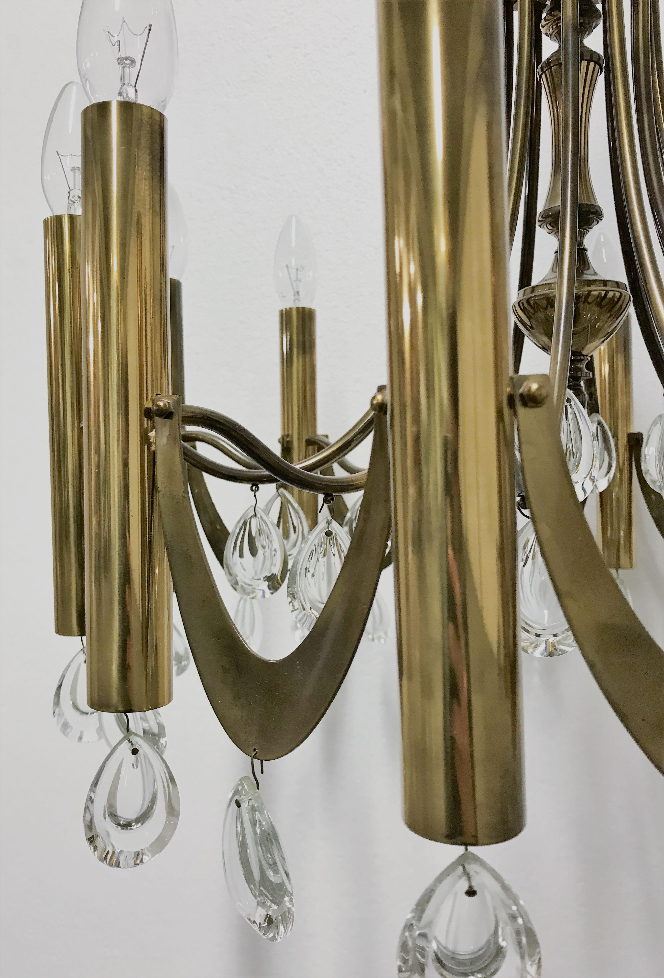 Stunning mid century Gaetano Sciolari chandelier.

This light fixture has a more classical design with twelve candlestick lightpoints and crystal prisms.

The chandelier will look more 'of this time' without the crystal decorations, but we