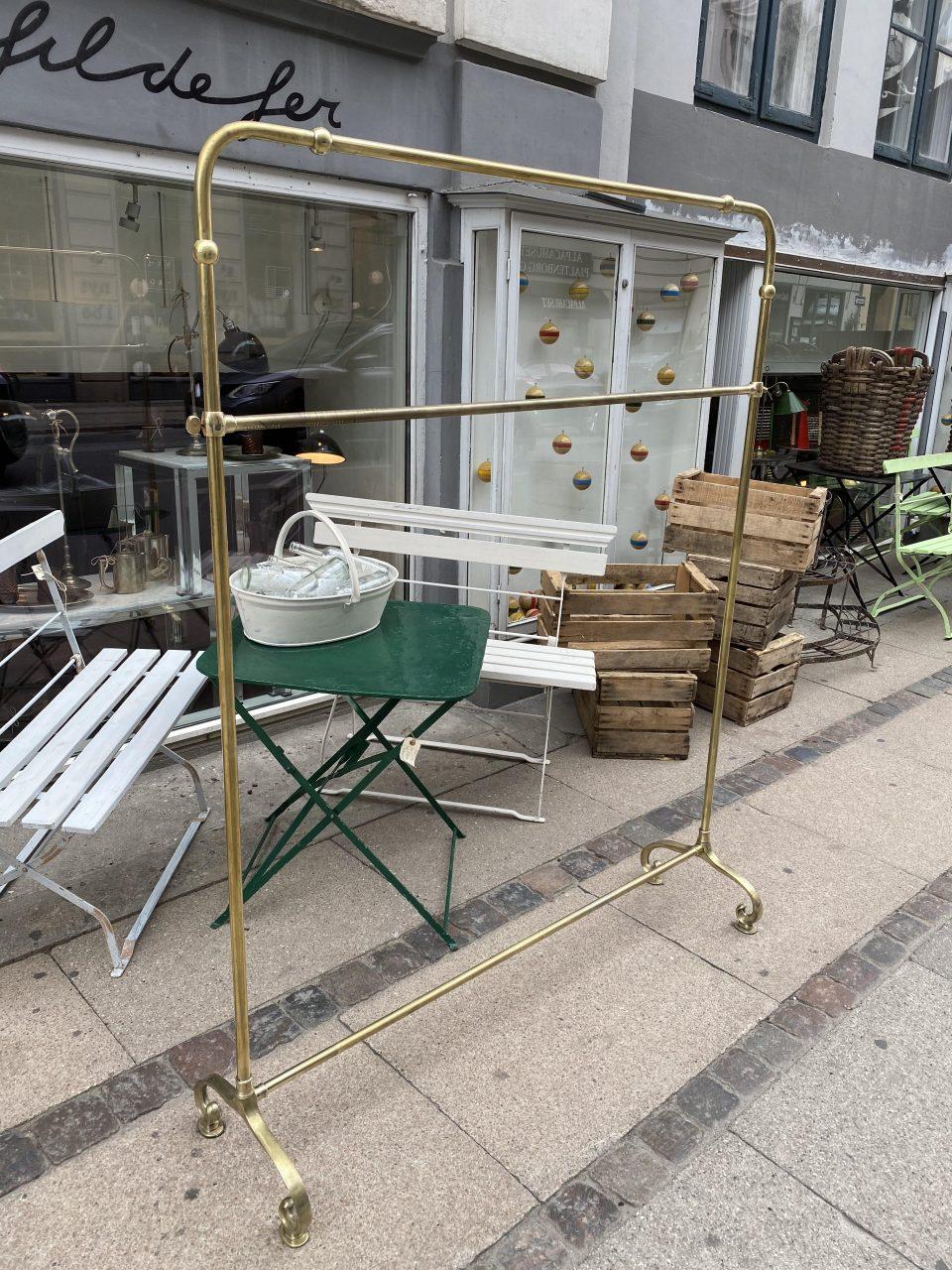 Elegant and simple French clothes rack / railing, circa 1900s. Art Nouveau style. Solid quality brass, with adjustable horizontal railing. Provenance – a now closed warehouse in central Lyon, which was used for Pret-a-porter ready to wear designs.