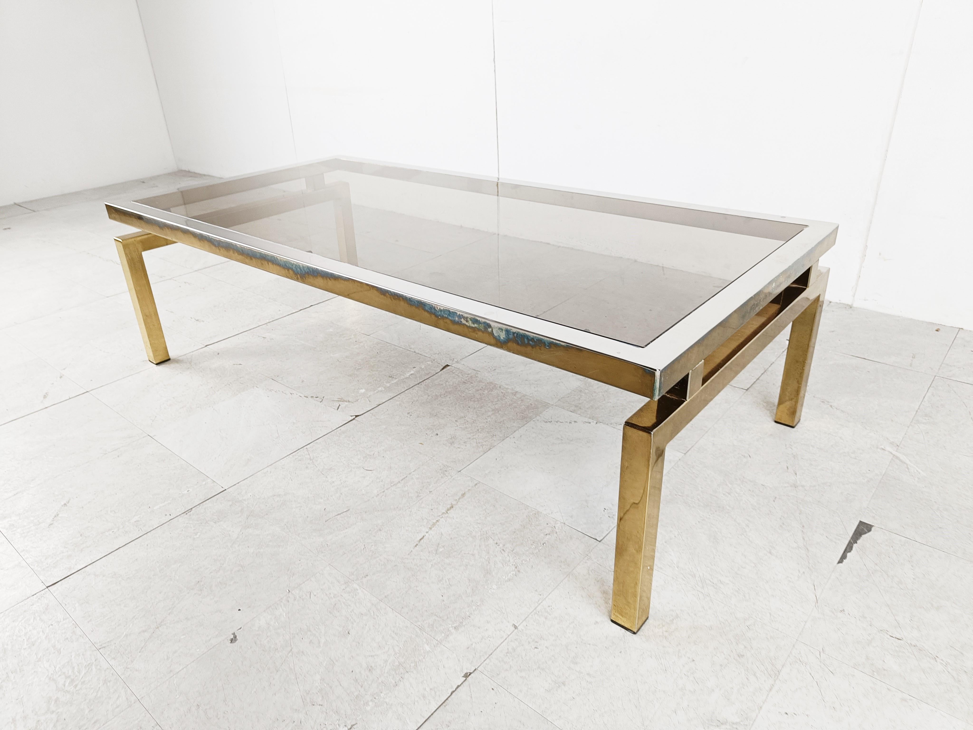 Seventies coffee table with smoked glass and a brass and chrome frame.

The brass has faded in some areas.

This is a table for someone who really likes a little 'worn' vintage look.

The table still is very elegant.

1970s -