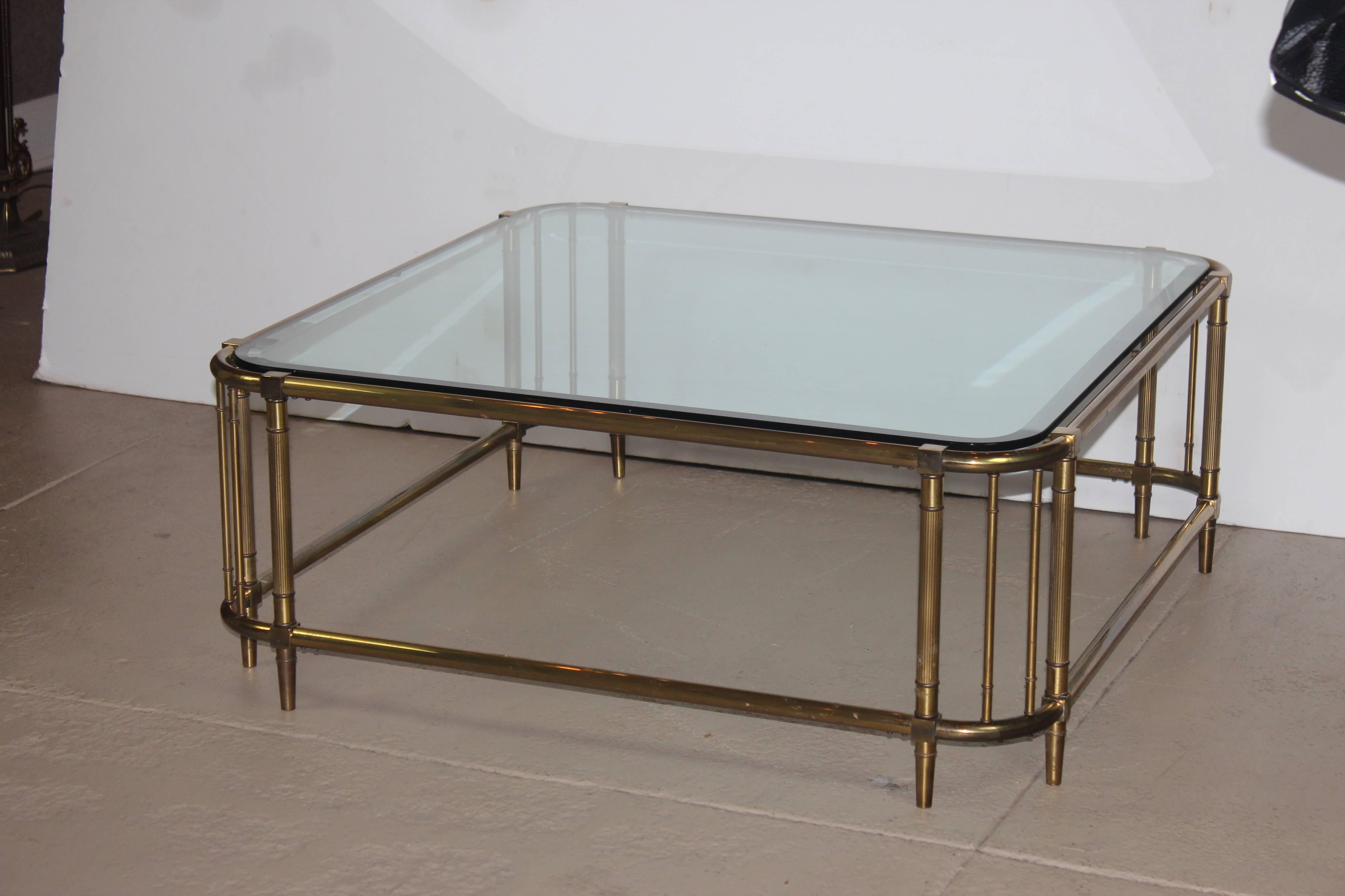 Square shape brass coffee table with bevelled glass top.