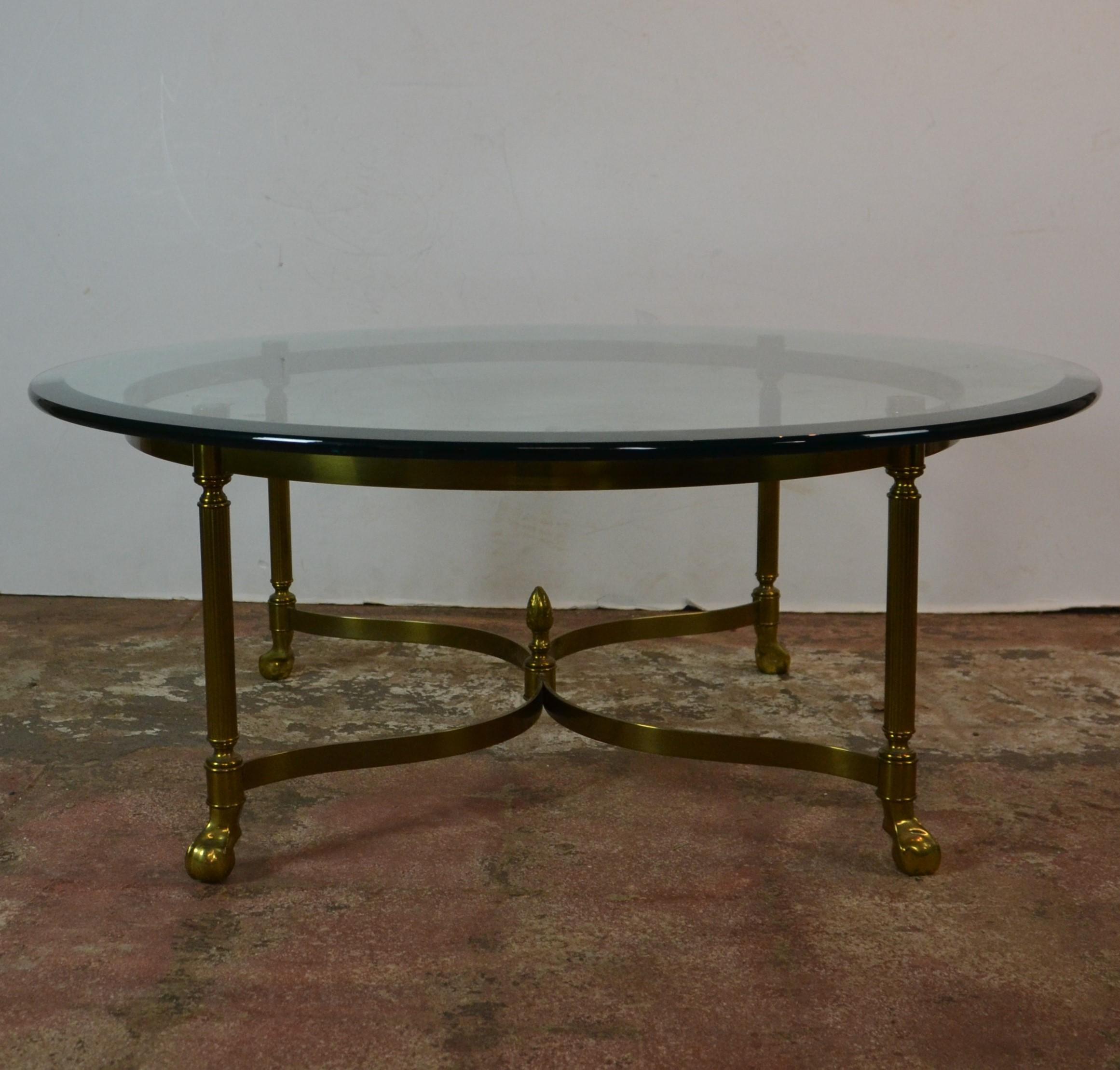 Round shape beveled edge glass top brass base coffee table.