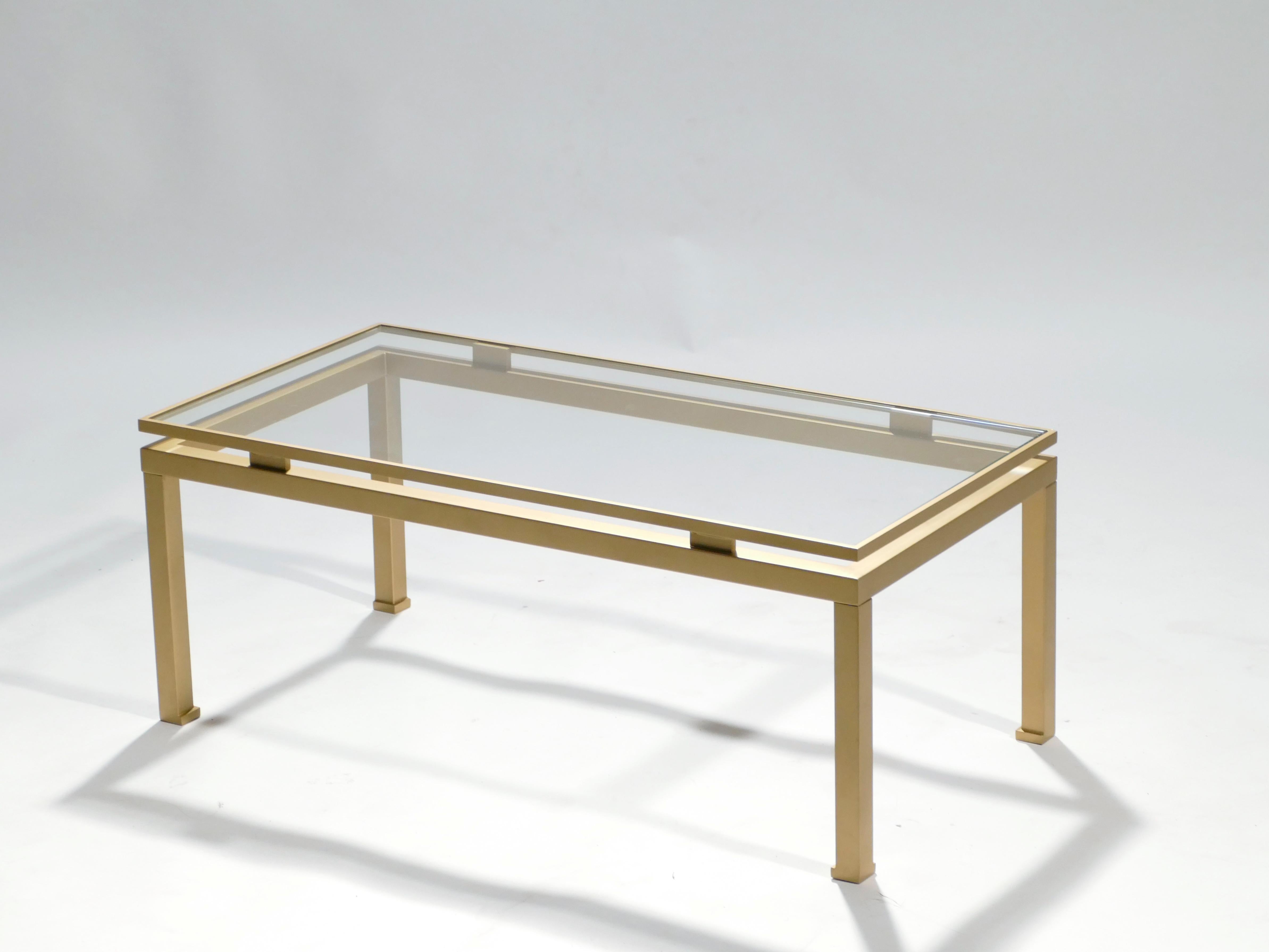 Simple lines point to this coffee table’s midcentury roots. Designed by Guy Lefevre for Maison Jansen, it features silky brass legs and a glass top. Its symmetry, elevated glass, and strong architectural design combine to create a subtle 1970s feel.