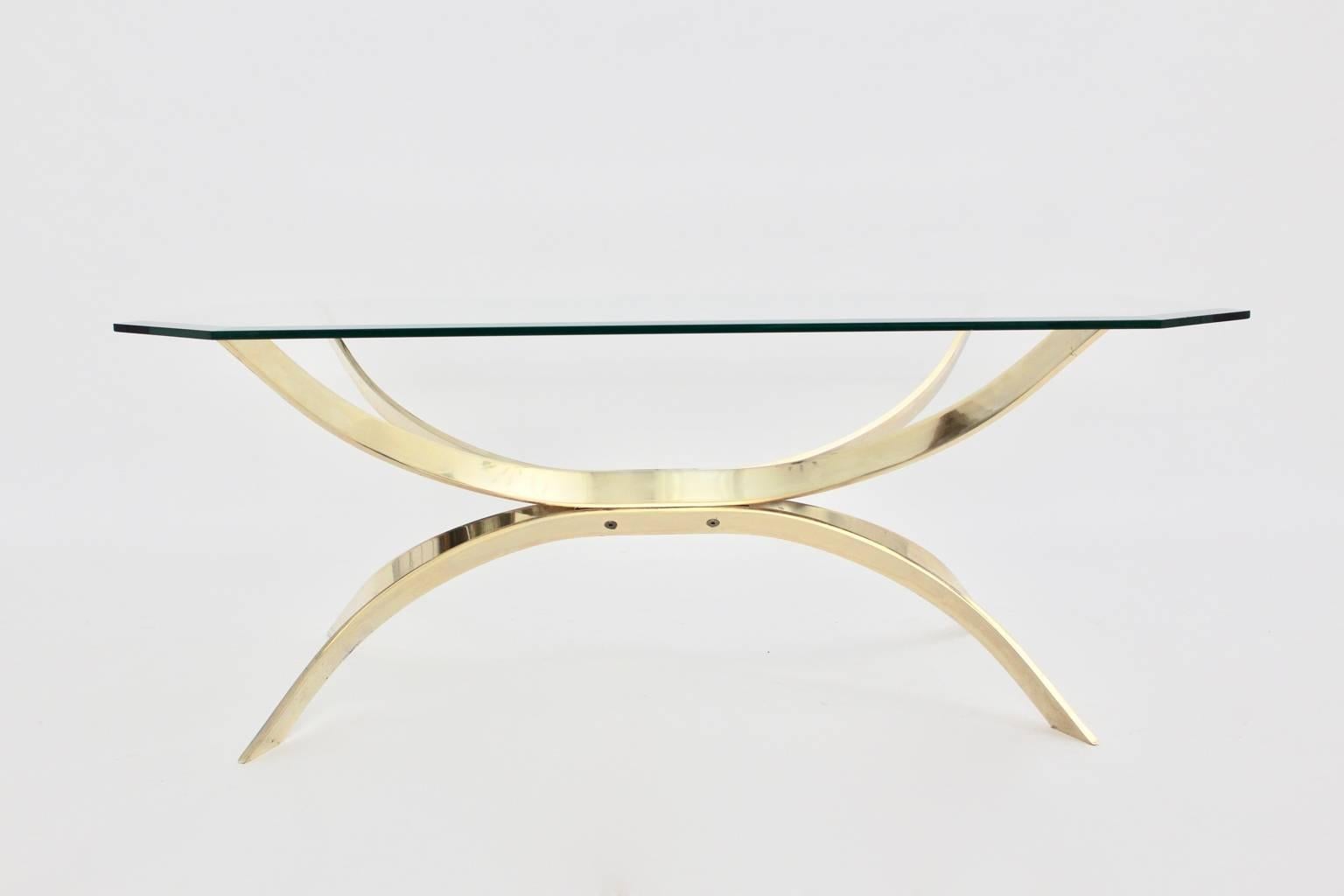 Great coffee table from the 1970s with a brass-plated base and an octagonal glass top, which is decorated with a facet. 
This coffee table appears very light and elegant.

The condition is very good with very minor signs of age and