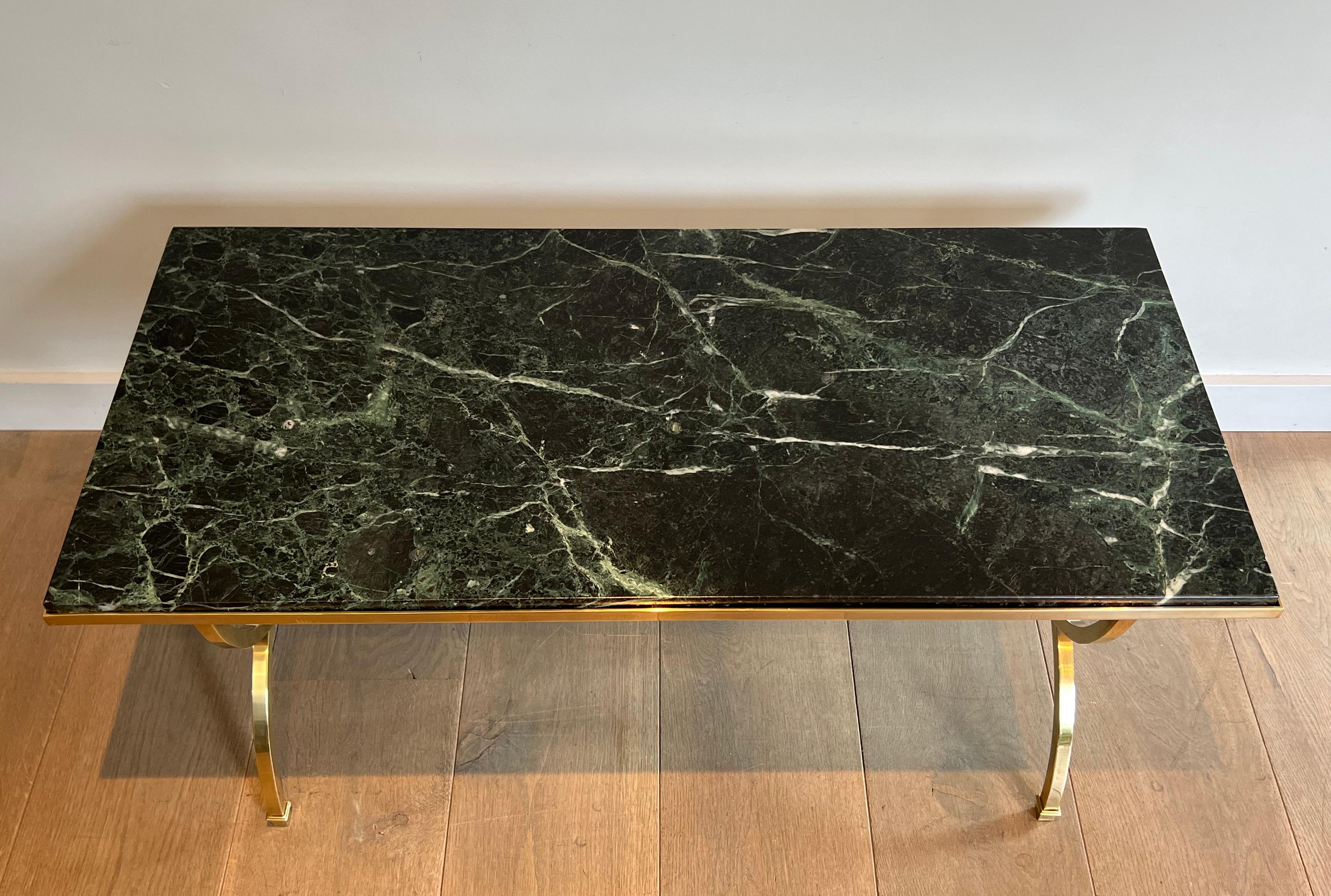 This very nice neoclassical style coffee table is made of a hoop brass base with a Green Marble Top. This is a French work by famous designer Maison Jansen. Circa 1940
