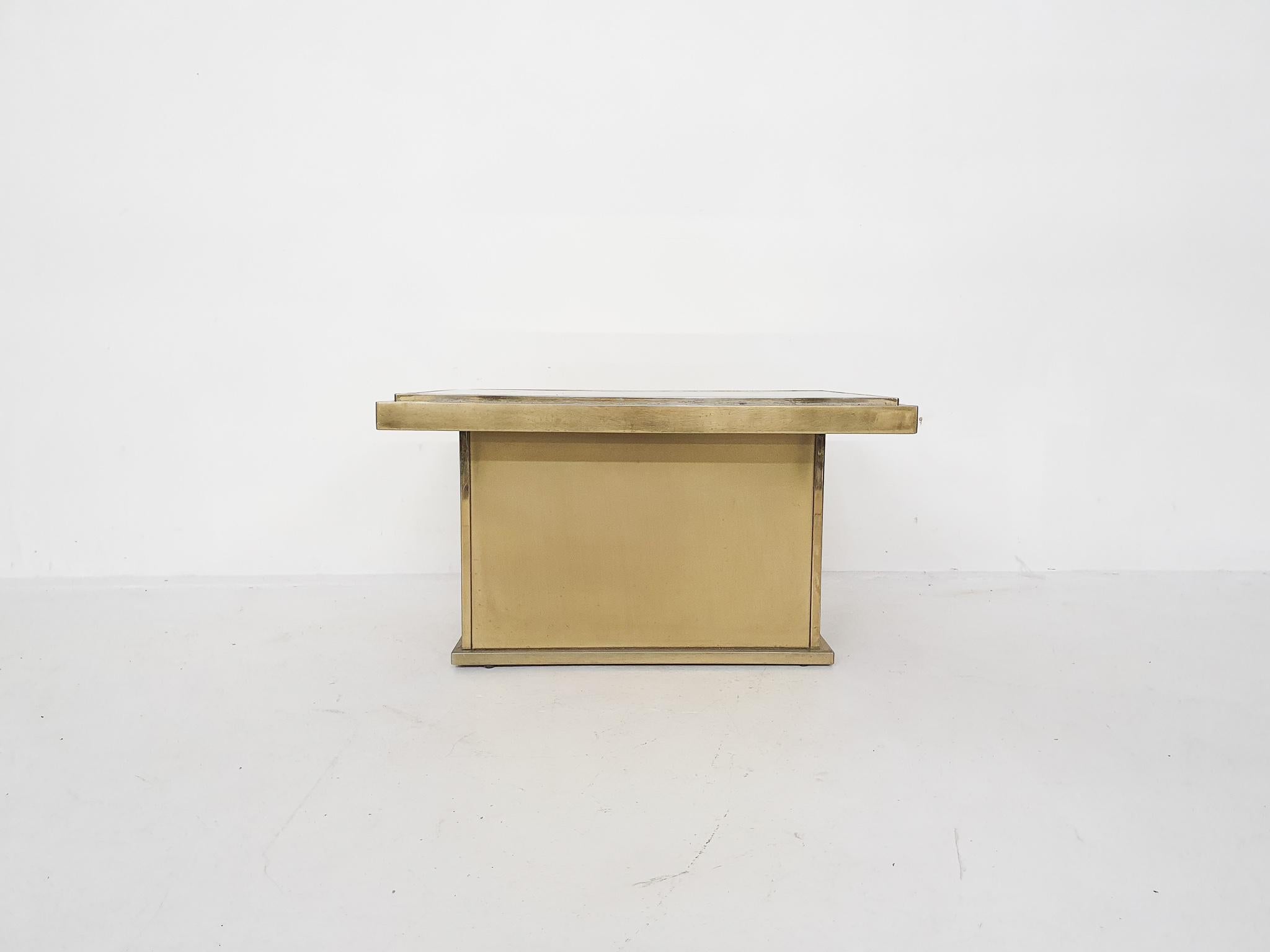 Hollywood Regency brass coffee table with mirrored glass top.