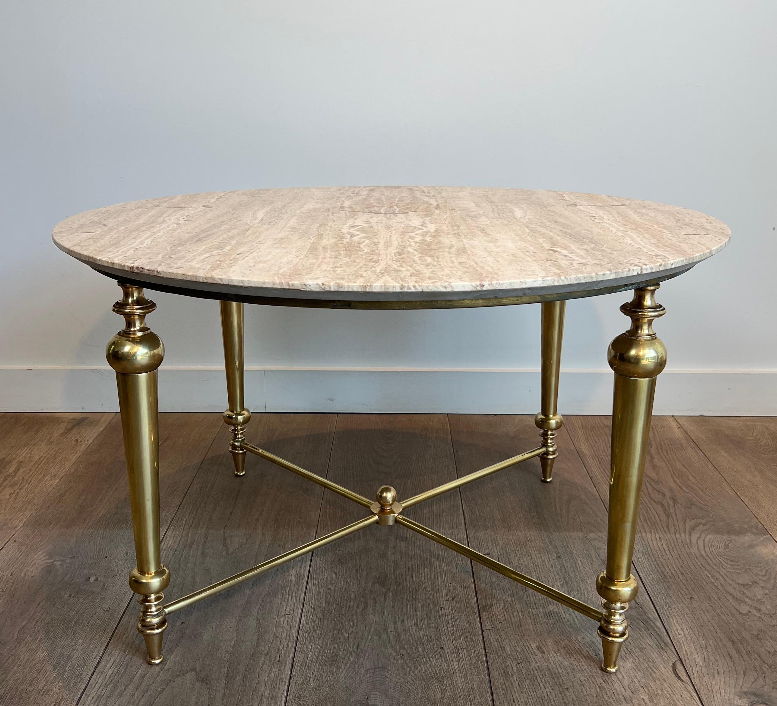 This very nice coffee table is made of brass with travertine top. This is a French work in the style of Maison Ramsay. Circa 1970