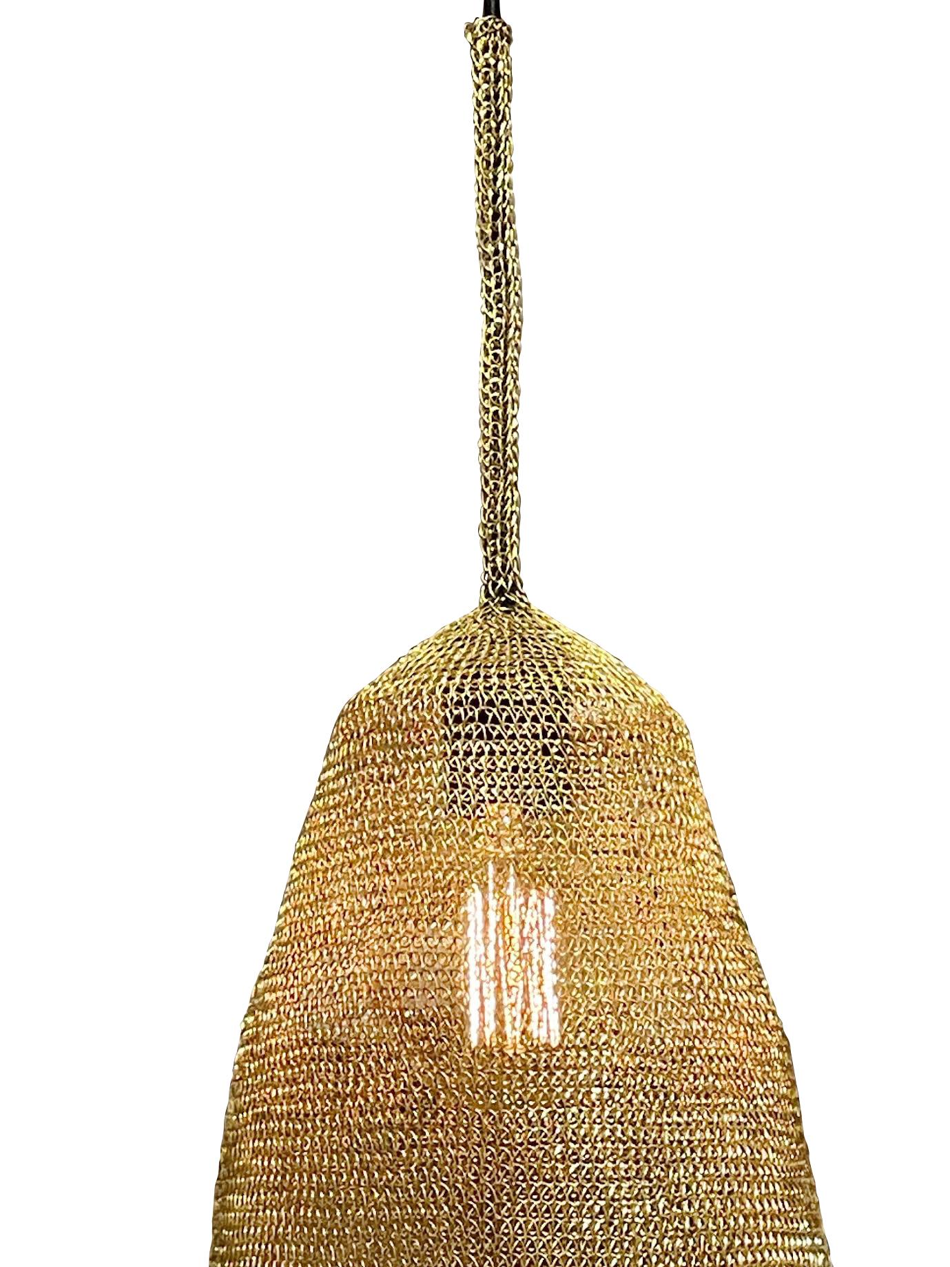 Contemporary Botswana knitted steel mesh pendant.
Brass color.
Black metal cap and cord  72
