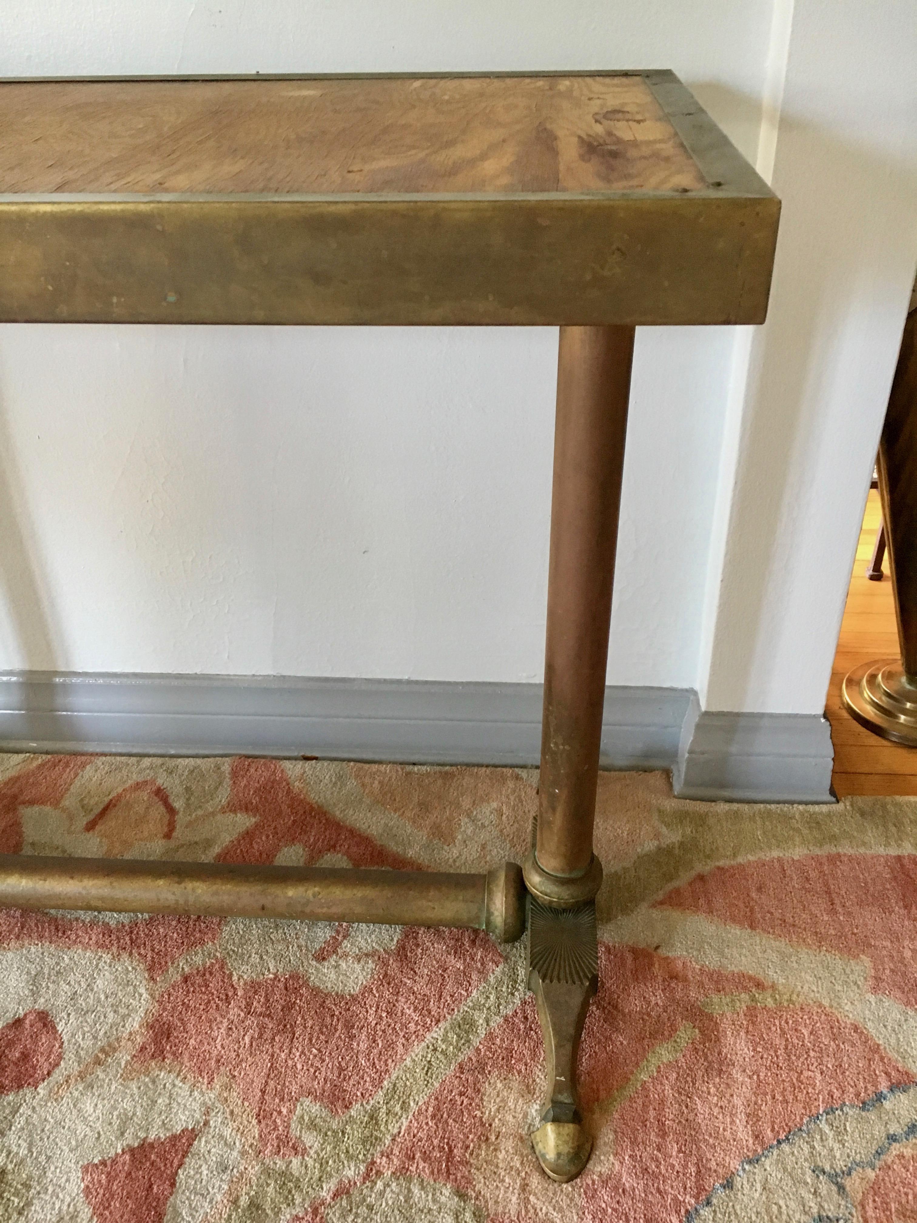 Very unique and handsome brass console table with beautifully detailed legs - a true vintage stunner.

Wonderful in any part of the home - sofa or console table, Library, or as a desk - study table in den or kitchen.

The top of plywood is